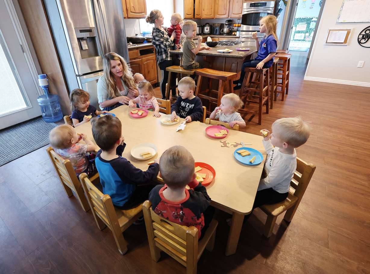 Child care provider Holly Kingston gives children a snack at her home in West Jordan on Friday. Parents, children, educators, and supporters gathered at the Capitol for Child Care Day on the Hill.