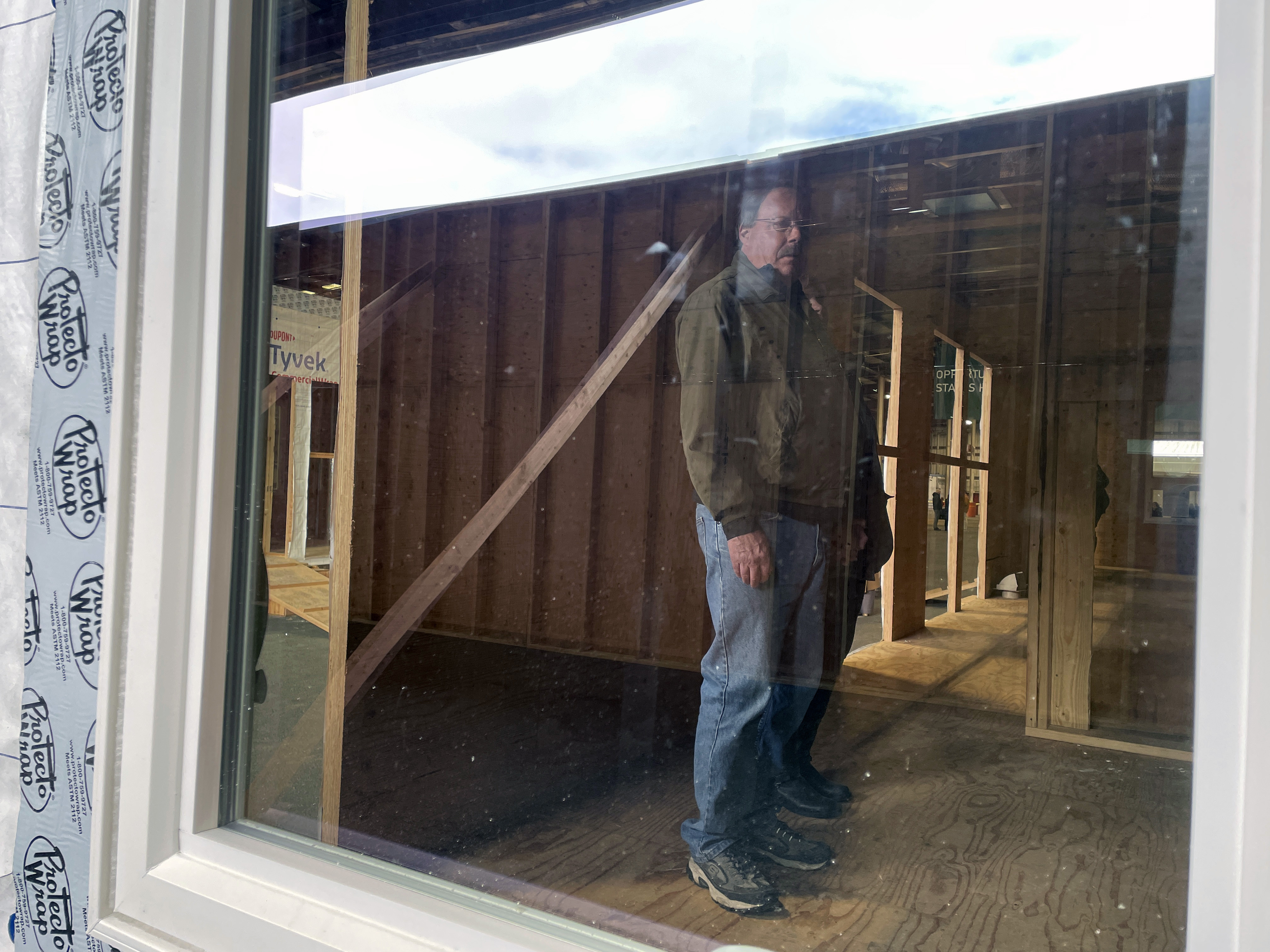 Scott Benedict checks out the inside of the mass timber affordable housing prototype that will soon become his new home while at the Port of Portland, Jan. 27, in Portland, Ore.