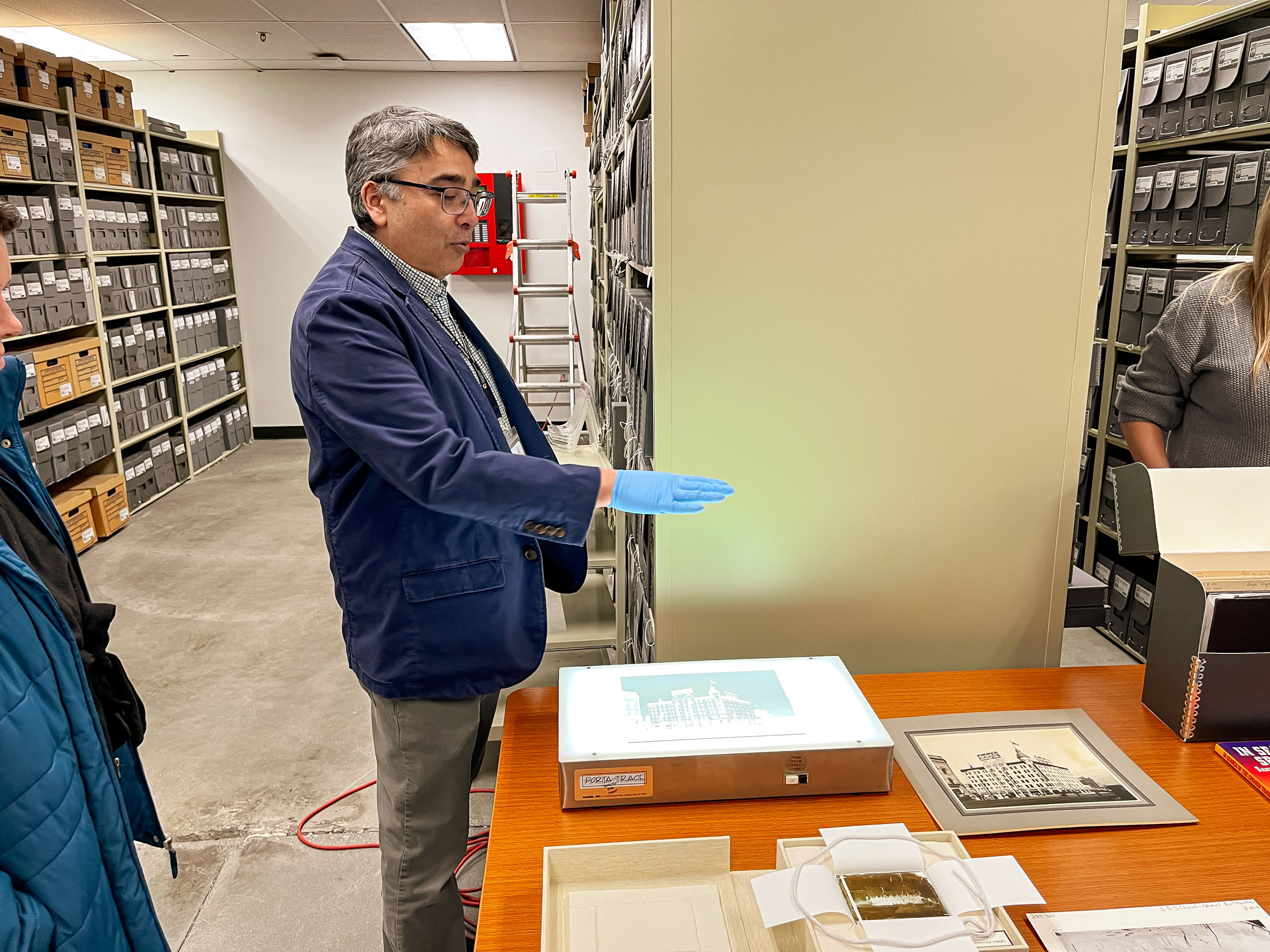 Doug Misner, the library and collections coordinator for the Utah Division of State History, showcases a photo negative glass plate during a tour held inside a temporary state history collections facility in Midvale on Jan. 27.