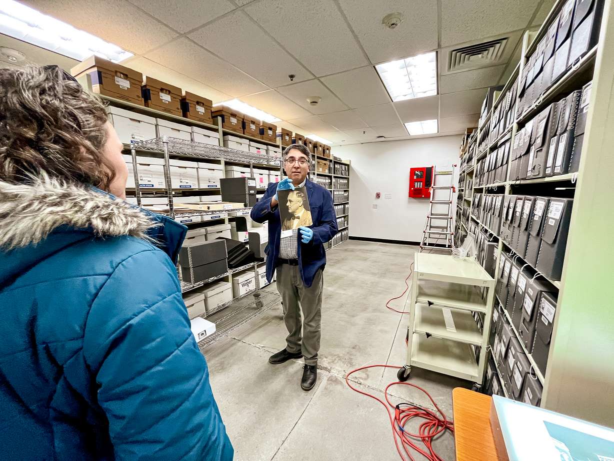 Doug Misner, the library and collections coordinator for the Utah Division of State History, holds a signed photo of President Franklin D. Roosevelt during a tour held inside a temporary state history collections facility in Midvale on Jan. 27.