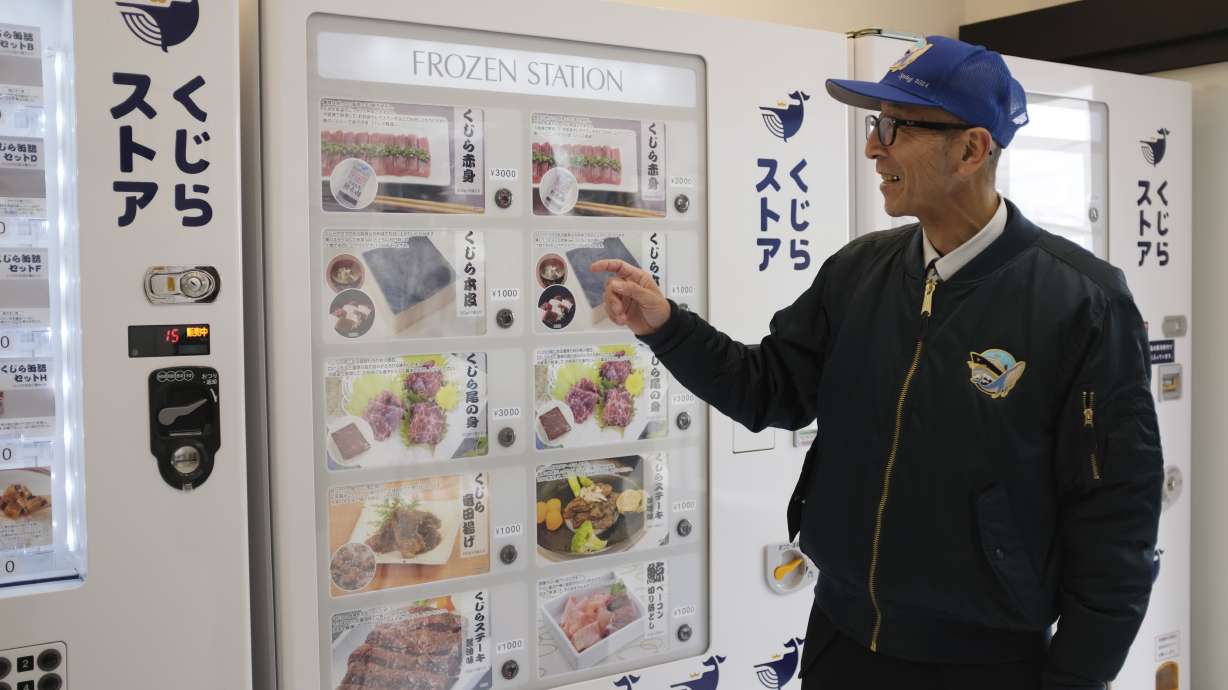 Konomu Kubo, a spokesperson for Kyodo Senpaku Co., explains how whale meat is being sold from a vending machine at the firm's store, Thursday in Yokohama, Japan.