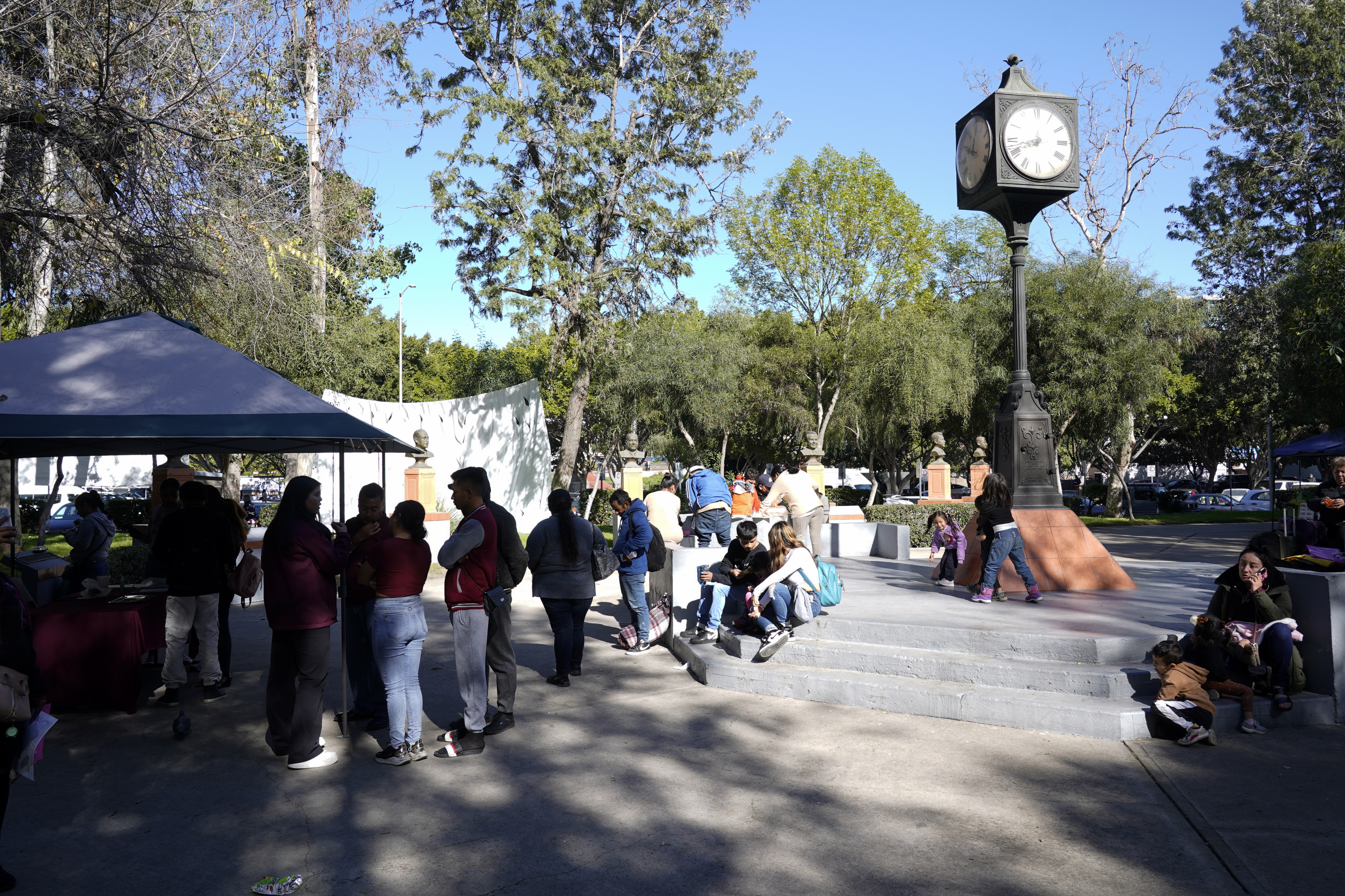 Migrants wait for help at a location set up by the city of Tijuana, Mexico, to assist migrants with the CBPOne app Tuesday. A mobile app for migrants to seek asylum in the United States has been overwhelmed since it was introduced this month in one of several major changes to the government's response to unprecedented migration flows.
