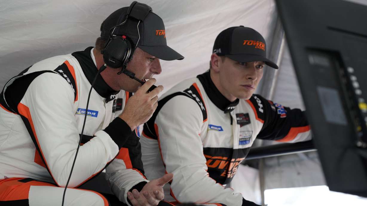 Scott McLaughlin, left, of New Zealand and Josef Newgarden look over a monitor in their pit stall during auto race testing for the upcoming Rolex 24 hour race at Daytona International Speedway, Friday, Jan. 20, 2023, in Daytona Beach, Fla.