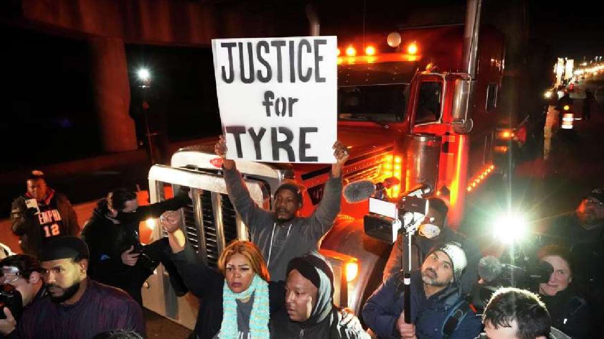 Protesters march down the street Friday in Memphis, Tenn., as authorities release police video depicting five Memphis officers beating Tyre Nichols, whose death resulted in murder charges and provoked outrage at the country's latest instance of police brutality.