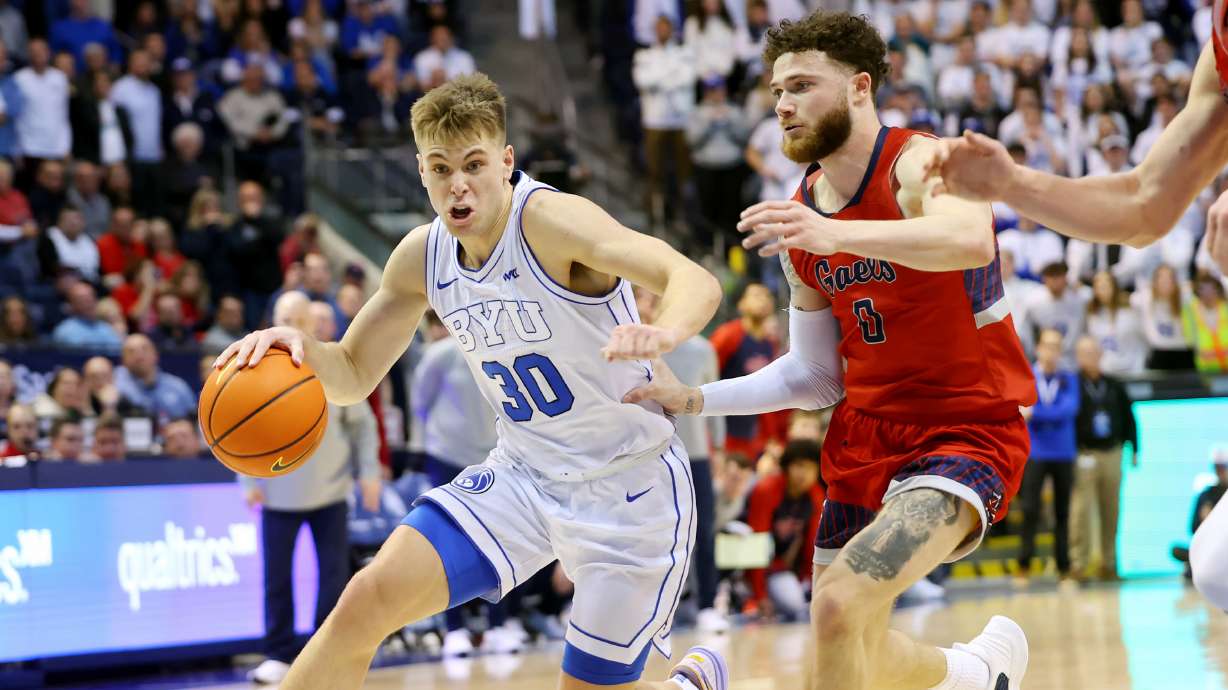 Brigham Young guard Dallin Hall (30) drives toward the basket with Saint Mary's Gaels guard Logan Johnson (0) defending as BYU and Saint Mary’s play at the Marriott Center in Provo on Saturday, Jan. 28, 2023. The Gaels won 57-56.