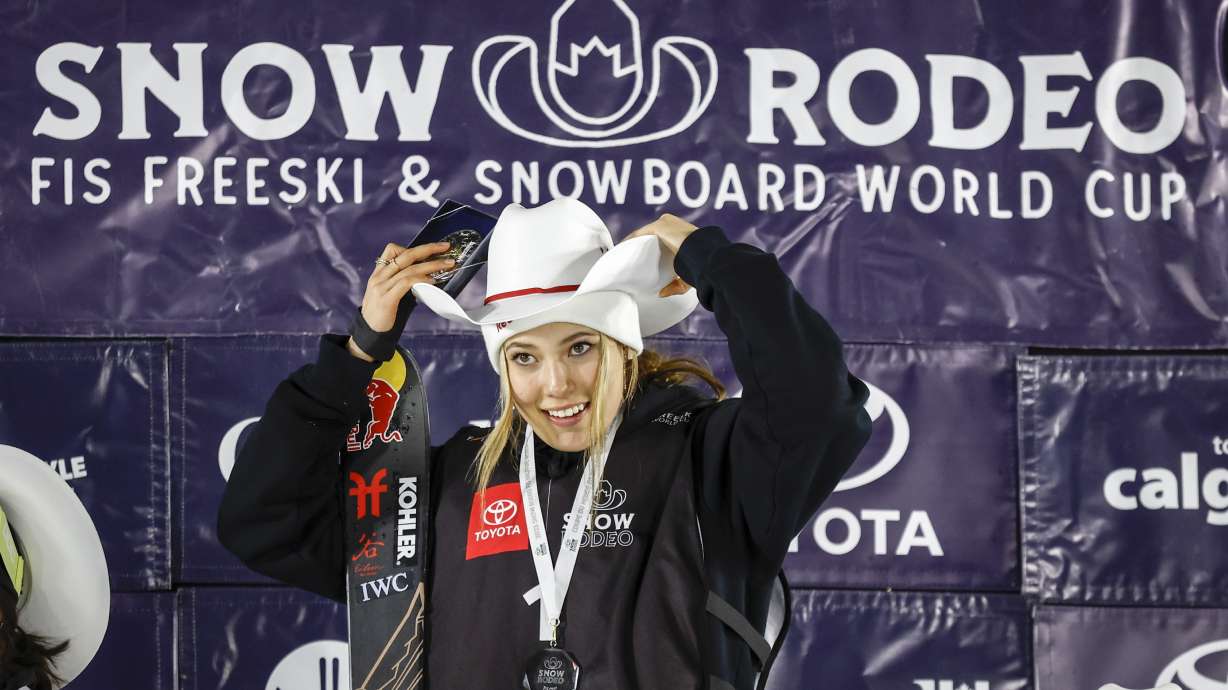 Eileen Gu of China celebrates on the podium after her victory in the women's World Cup freestyle ski halfpipe event in Calgary, Alberta, Saturday, Jan. 21, 2023.