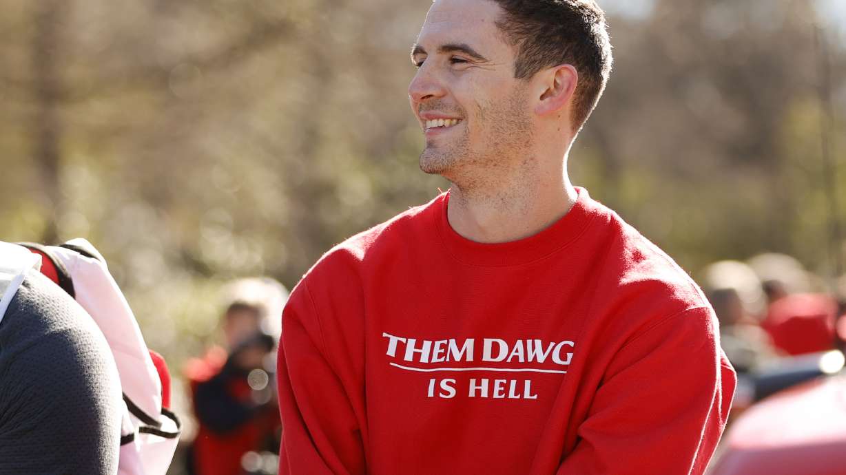 Georgia quarterback Stetson Bennett smiles at the crowd during a parade celebrating the Bulldog's second consecutive NCAA college football national championship, Saturday, Jan. 14, 2023, in Athens, Ga.