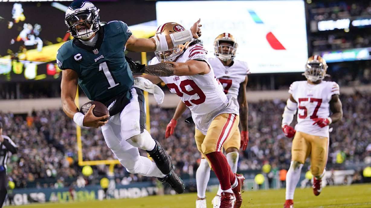 Philadelphia Eagles quarterback Jalen Hurts (1) is pushed out of bounds by San Francisco 49ers safety Talanoa Hufanga (29) during the second half of the NFC Championship NFL football game between the Philadelphia Eagles and the San Francisco 49ers on Sunday, Jan. 29, 2023, in Philadelphia.