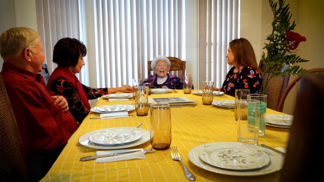 Rose Tonti chats with friends and family over lunch. With over 100 years of life experience, she has some insight to share.