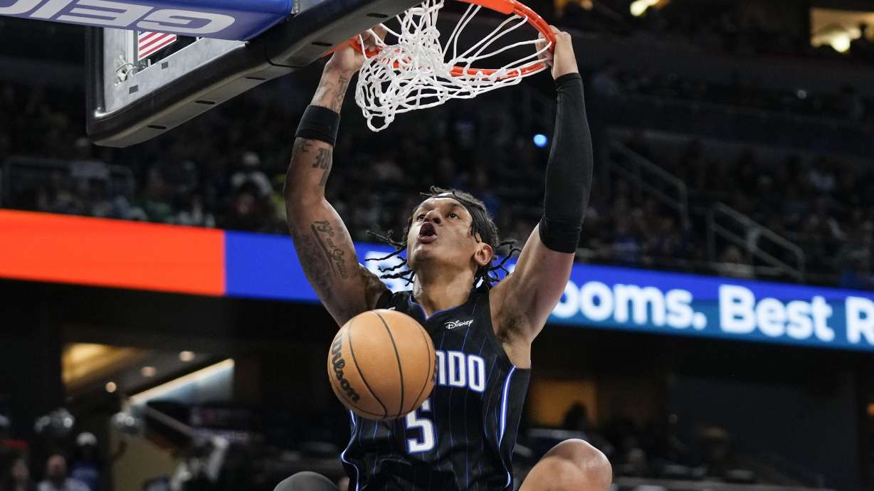 Orlando Magic's Paolo Banchero makes an uncontested dunk against the Boston Celtics during the second half of an NBA basketball game, Monday, Jan. 23, 2023, in Orlando, Fla.