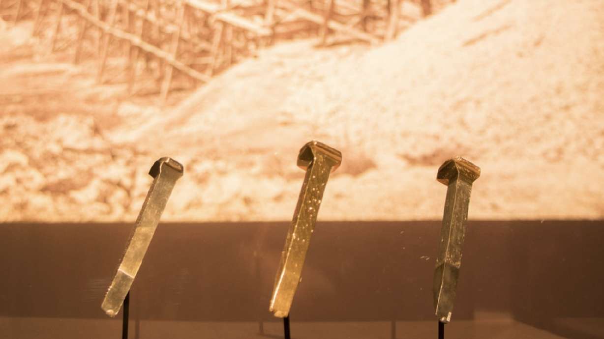 The Arizona spike, right, is displayed next to the famed golden and Nevada spikes at the Utah Museum of Fine Arts in Salt Lake City on Jan. 31, 2019. All three were driven at Promontory Summit in 1869. The Arizona spike sold last week for more than $2 million.