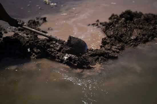 Adan Vallejo blocks water with mud as he irrigates a field of cotton with water from the Colorado River, Aug. 14, 2022, near Ejido Mezquital, Mexico. Competing priorities, outsized demands and the federal government's retreat from a threatened deadline all combined to thwart a voluntary deal last summer on how to drastically cut water use from the parched Colorado River, according to emails obtained by the Associated Press.