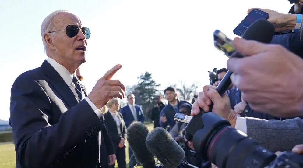 President Joe Biden talks with reporters on the South Lawn of the White House in Washington, Monday. Biden has informed Congress that he will end the twin national emergencies for addressing COVID-19 on May 11.