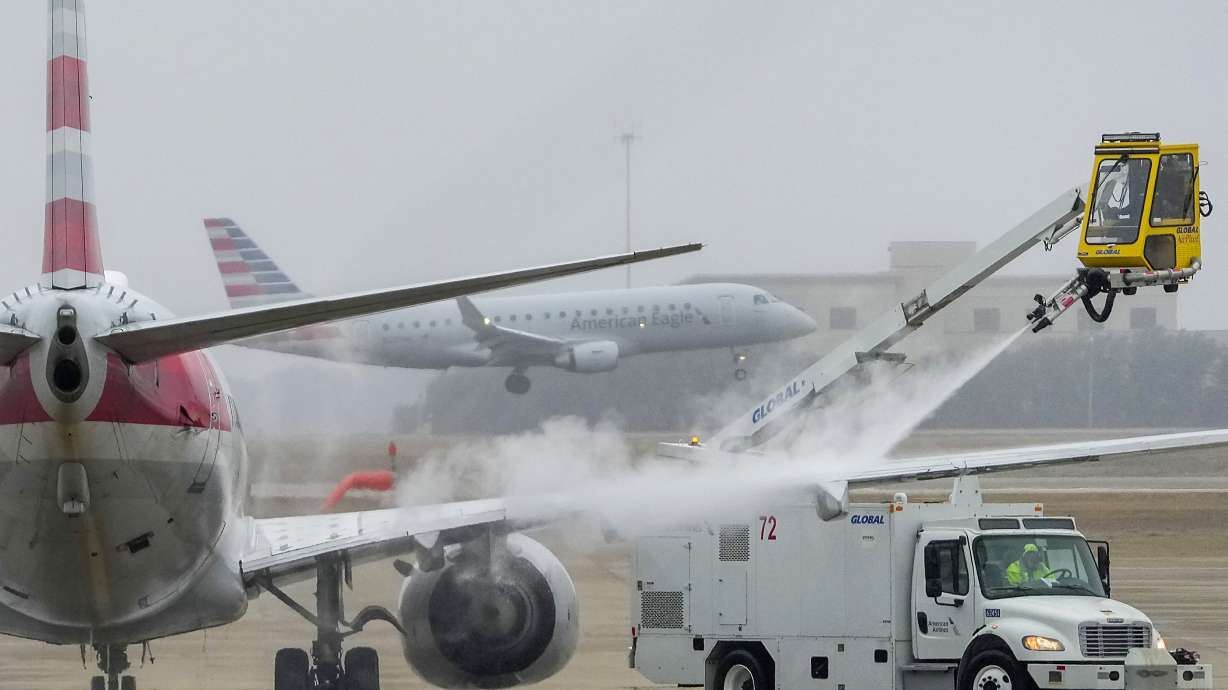 An American Airlines aircraft undergoes deicing procedures on Monday, at Dallas/Fort Worth International Airport in Texas.
