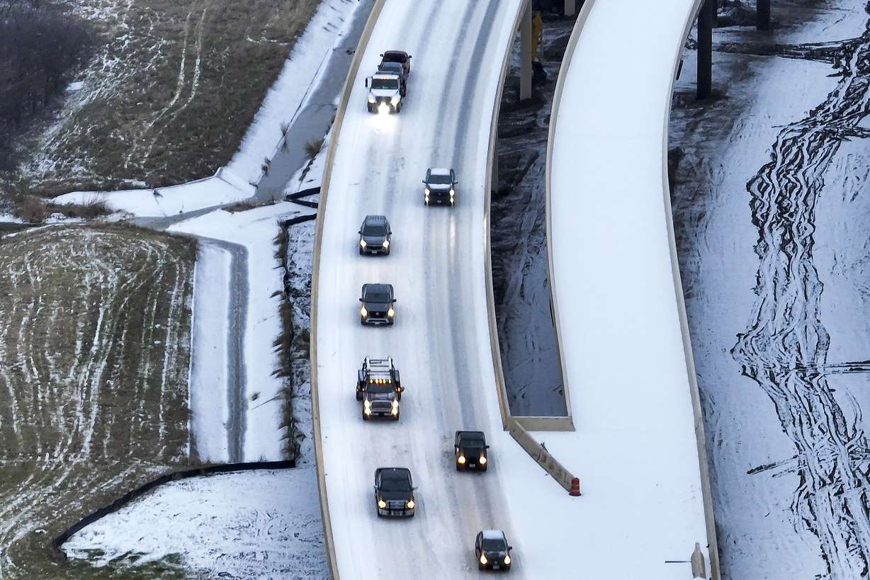 An icy mix covers Highway 114 on Monday in Roanoke, Texas. Dallas and other parts of North Texas are under a winter storm warning through Wednesday.