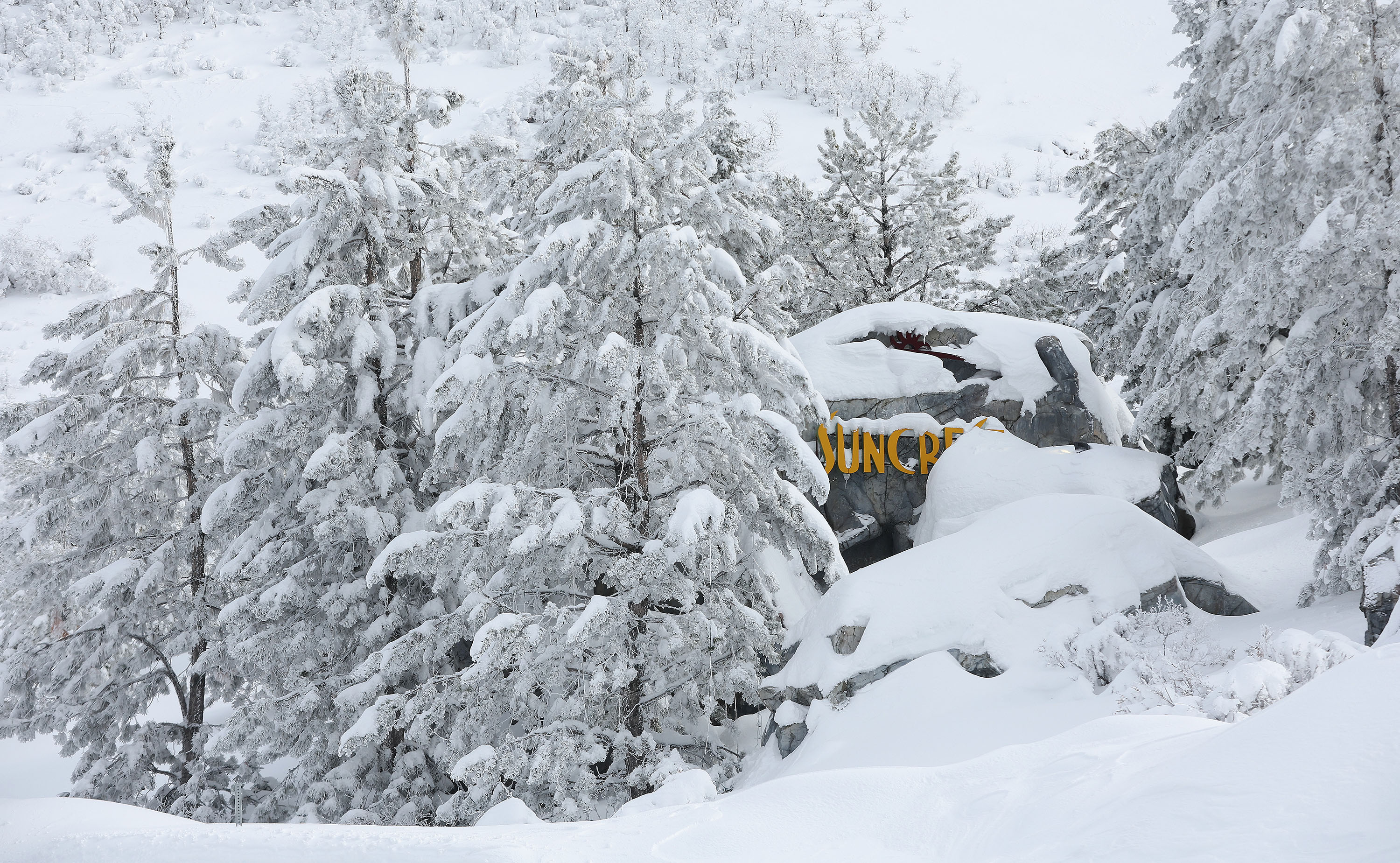 Snow covers the Suncrest sign in Draper on Jan. 18. A cold front that passed through Sunday dropped temperatures to below-freezing all over Utah. Meteorologists say temperatures are expected to gradually return to normal over the next few days.