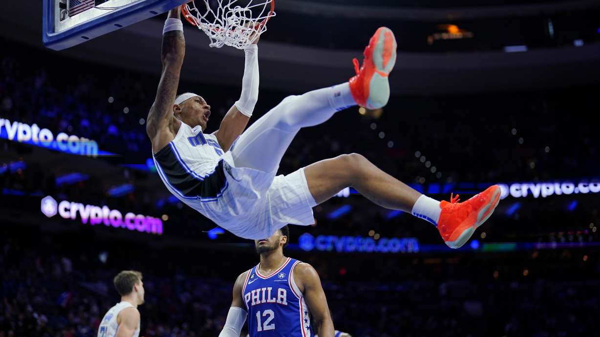 Orlando Magic's Paolo Banchero, top, dunks during the second half of an NBA basketball game against the Philadelphia 76ers, Monday, Jan. 30, 2023, in Philadelphia.