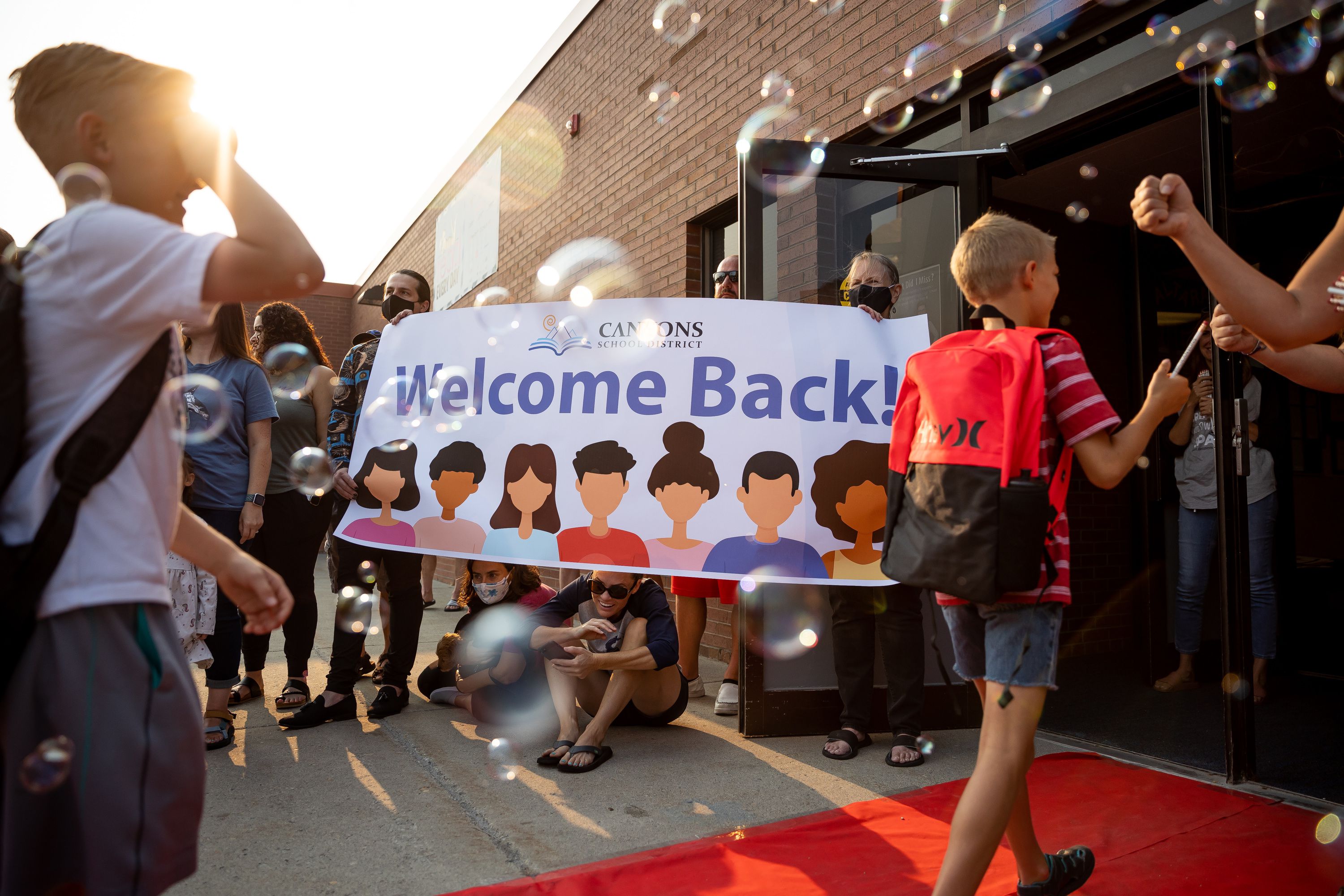 Parents and teachers watch as students parade into Altara Elementary in Sandy for the first day of school on Monday, Aug. 16, 2021. Children the world over experienced deficits equivalent to one-third of a school year's learning due to the COVID-19 pandemic, according to a new global analysis.