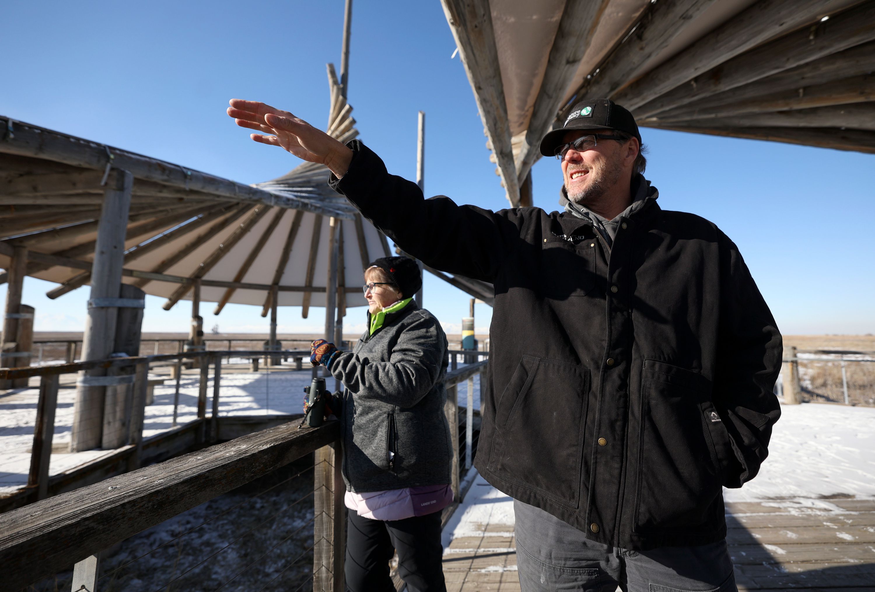 Ann Neville, The Nature Conservancy Utah northern mountains regional director, and Chris Brown, The Nature Conservancy Utah director of stewardship, look out over the Great Salt Lake Shorelands Preserve during a media interview in western Davis County on Tuesday.