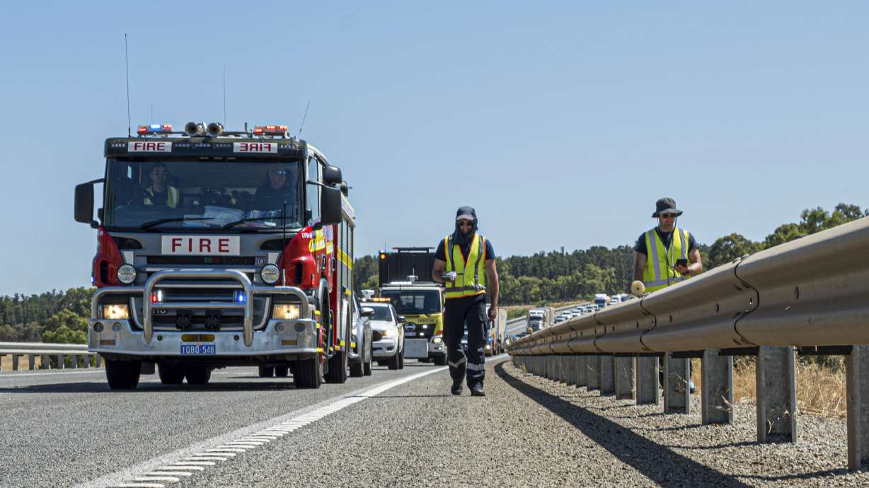 Emergency crews members search for a radioactive capsule believed to have fallen off a truck being transported on a freight route on the outskirts of Perth, Australia, Saturday. The capsule has been found, the authorities say.