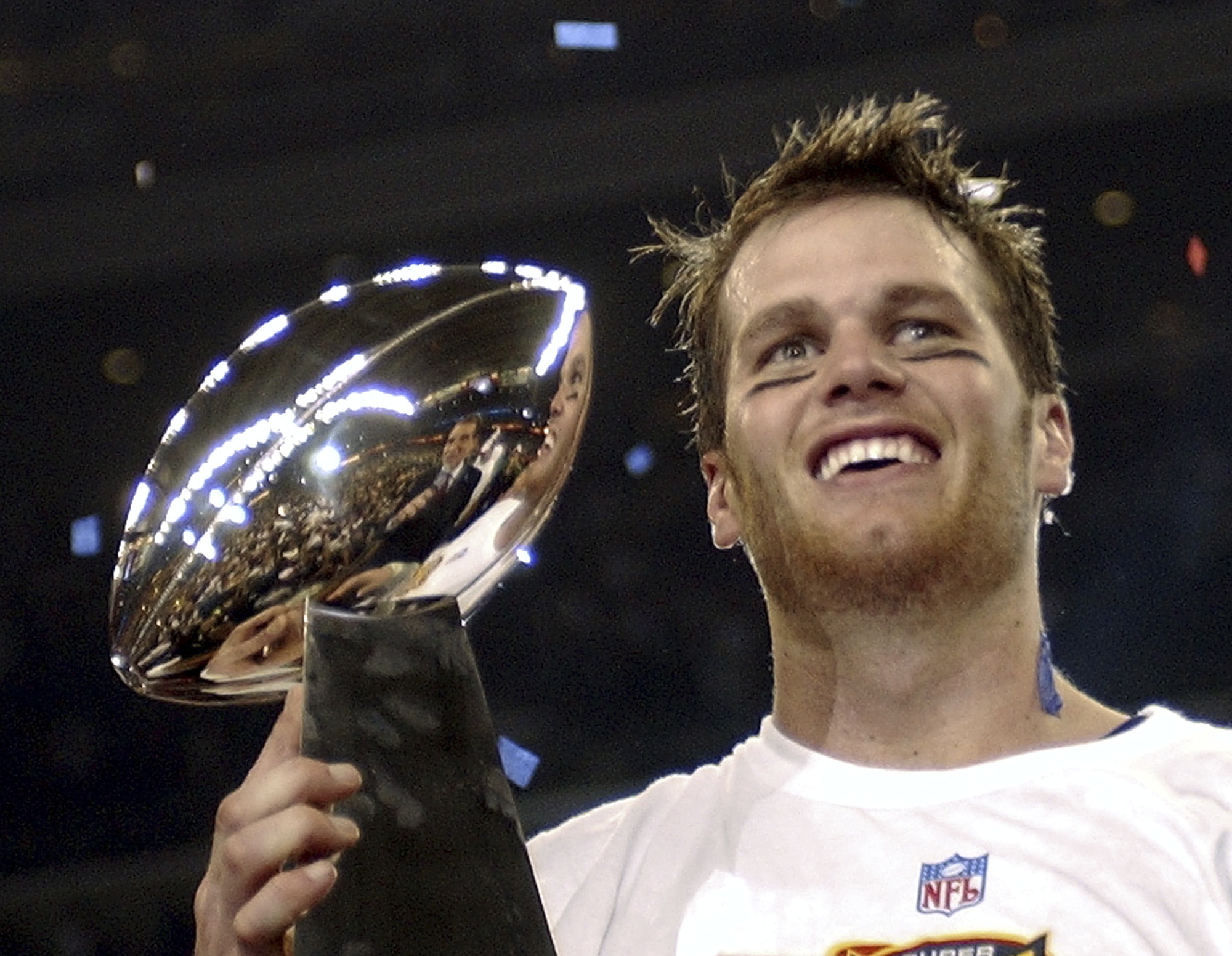 FILE - In this Feb. 1, 2004, file photo, New England Patriots quarterback Tom Brady holds the Vince Lombardi Trophy after the Patriots beat the Carolina Panthers 32-29 in Super Bowl 38 in Houston. Brady, who won a record seven Super Bowls for New England and Tampa, has announced his retirement, Wednesday, Feb. 1, 2023.