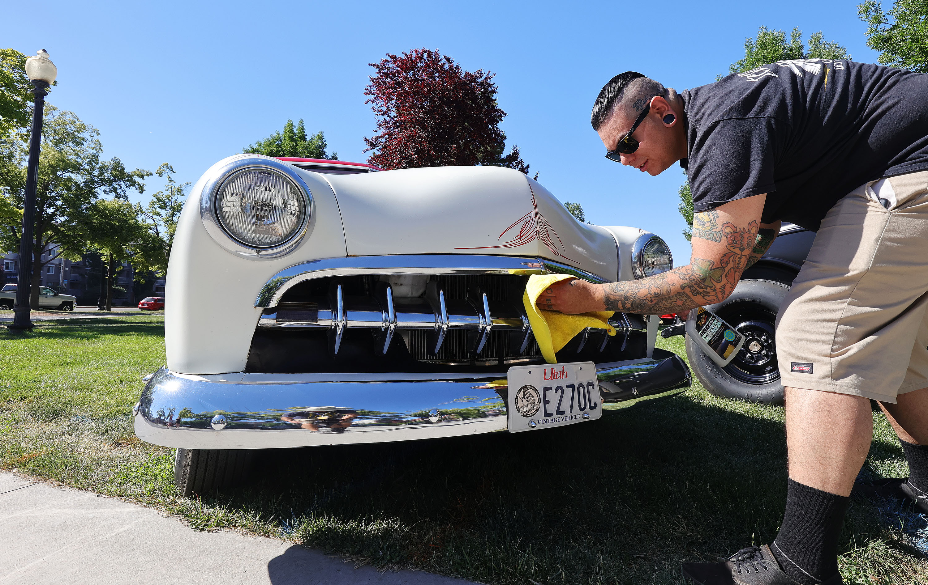 Nick Lobos cleans his 1950 Ford during the Rumble in the Park car show in Salt Lake City on June 13, 2021. A bill is being considered to "streamline" Utah's license plate process, including temporarily pausing new personalized license plates from being issued.