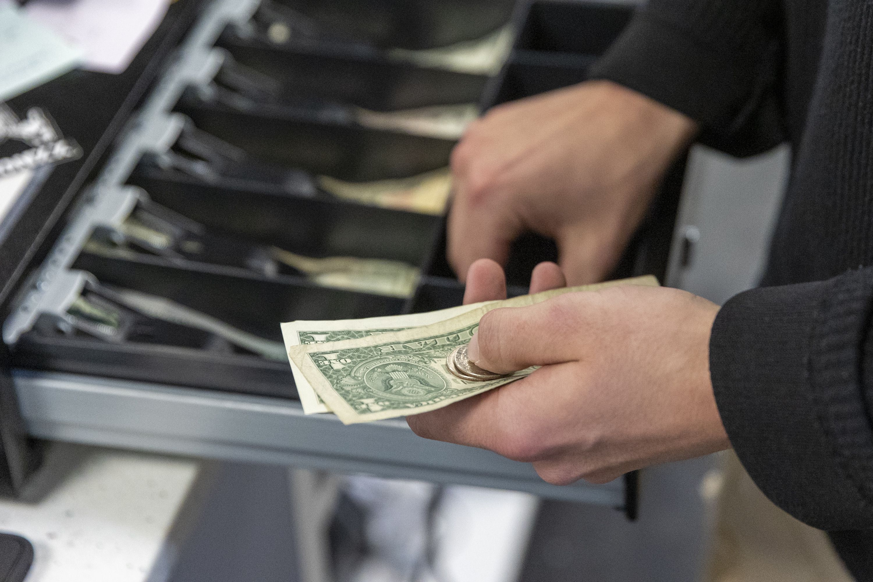 Almighty Originals manager Jamison Parker counts a customer’s change at the Shops at South Town in Sandy on Nov. 25, 2022. As widely expected, the Federal Reserve announced a .25% increase to its benchmark lending rate Wednesday.