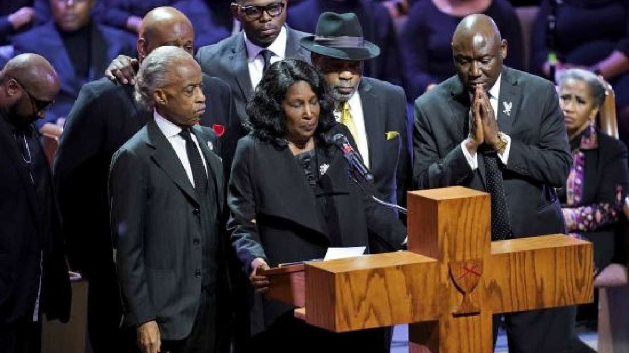 Flanked by Rev. Al Sharpton, left, her husband Rodney Wells, second from right, and attorney Benjamin Crump, right, RowVaughn Wells speaks during the funeral service for her son Tyre Nichols at Mississippi Boulevard Christian Church in Memphis, Tenn., on Wednesday. Nichols died following a brutal beating by Memphis police after a traffic stop.