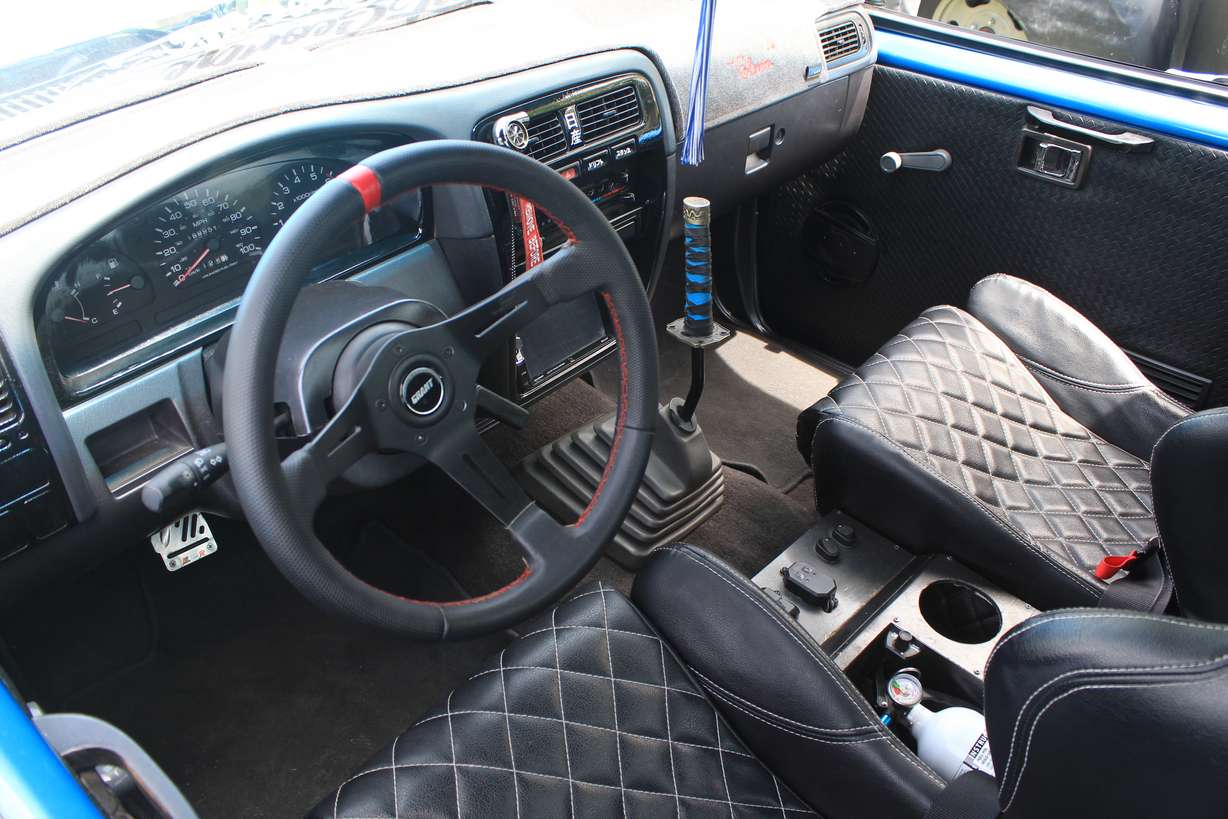 The interior of Samuel Edwards' 1986 Nissan Hardbody truck has a dash from a 1997 truck and Takana seats.