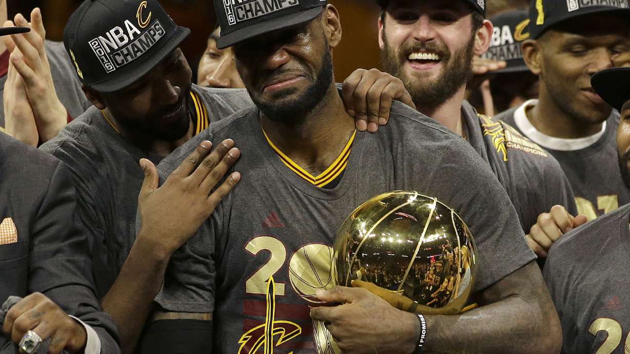 FILE -Cleveland Cavaliers forward LeBron James, center, celebrates with teammates after Game 7 of basketball's NBA Finals against the Golden State Warriors in Oakland, Calif., Sunday, June 19, 2016. LeBron James is about to pass Kareem Abdul-Jabbar as the NBA's career scoring leader. The AP is looking back at some of his top games along the way.
