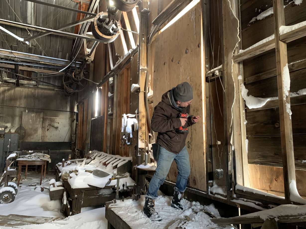 Crews patch up damage to a building at the old Chief Consolidated mine in Eureka. The mine closed in 1957 but remains a Utah Historic Site.