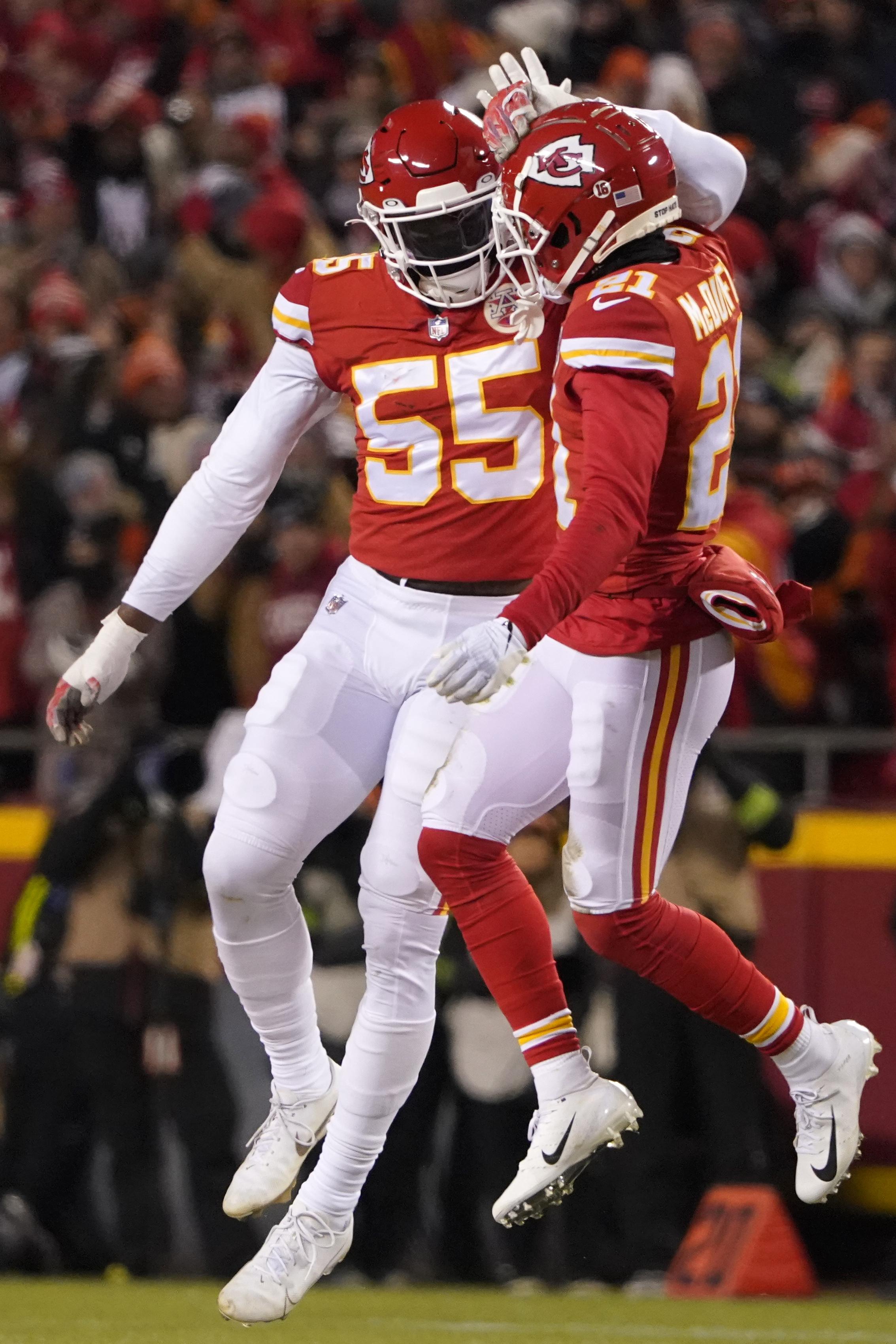 Kansas City Chiefs defensive end Frank Clark (55) celebrates with teammate cornerback Trent McDuffie (21) after sacking Cincinnati Bengals quarterback Joe Burrow during the first half of the NFL AFC Championship playoff football game, Sunday, Jan. 29, 2023, in Kansas City, Mo.