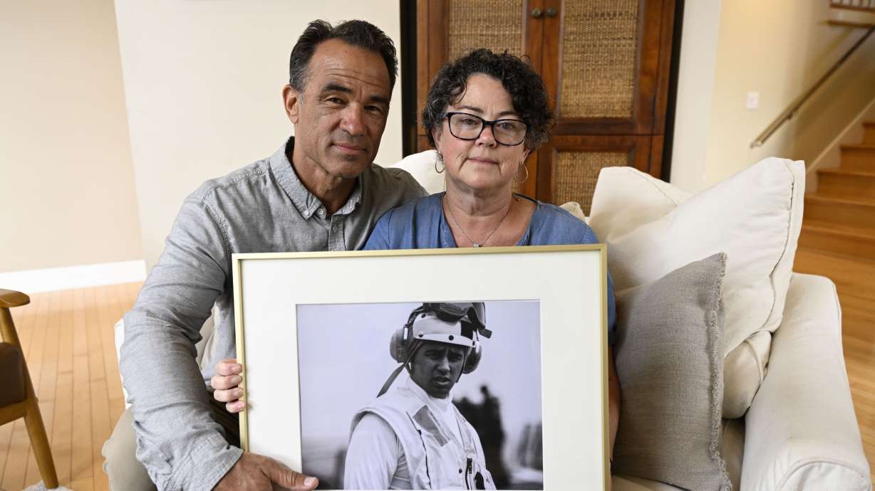 Derek and Suzi Alkonis pose with a photo of their son Lt. Ridge Alkonis on June 1, 2022, in Dana Point, Calif. In a series of tweets Thursday, Sen. Lee stated that Japan should return Lt. Ridge Alkonis to the U.S. no later than 11:59pm EST on Feb. 28.