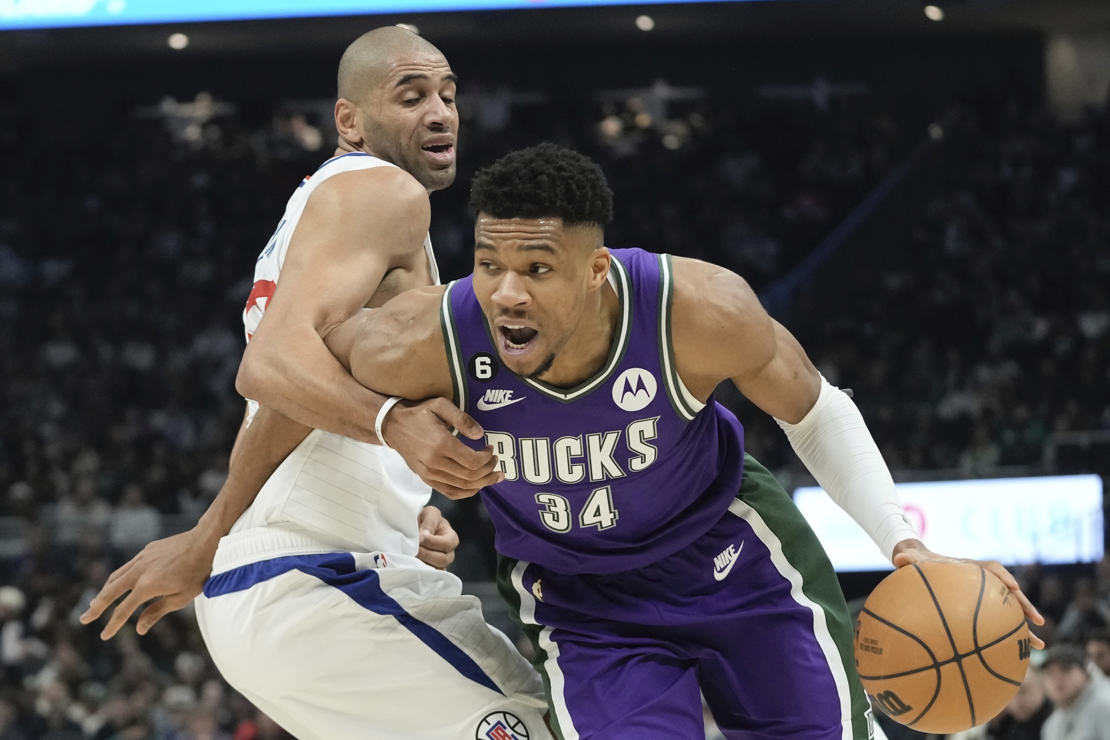 Los Angeles Clippers' Nicolas Batum fouls Milwaukee Bucks' Giannis Antetokounmpo during the first half of an NBA basketball game Thursday, Feb. 2, 2023, in Milwaukee. 
