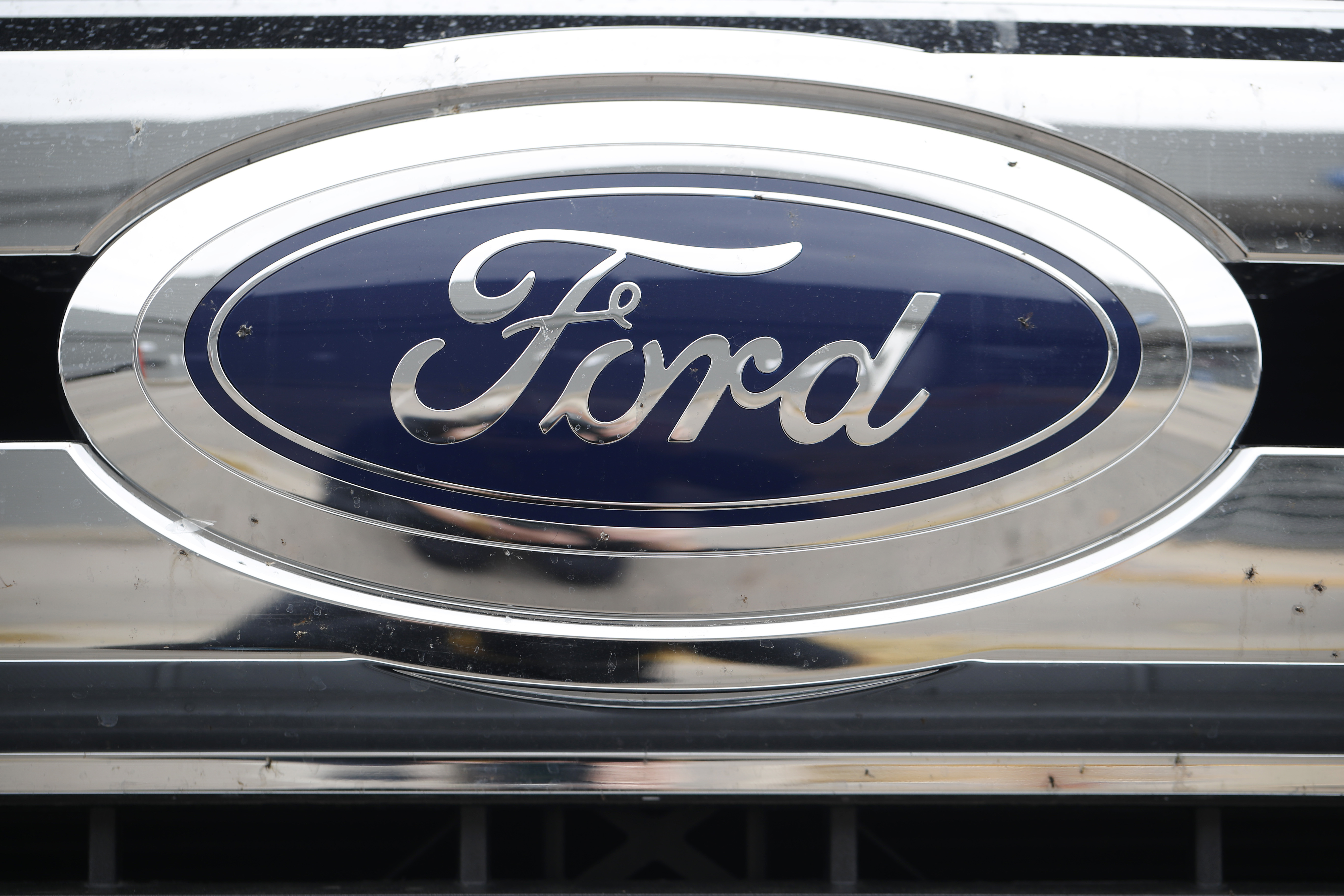 FILE - In this Sunday, Oct. 20, 2019, photograph, the company logo shines off the grille of an unsold 2019 F-250 pickup truck at a Ford dealership in Littleton, Colo. Ford reports financial earnings on Thursday, Feb. 2, 2023. 