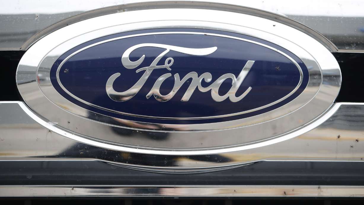 FILE - In this Sunday, Oct. 20, 2019, photograph, the company logo shines off the grille of an unsold 2019 F-250 pickup truck at a Ford dealership in Littleton, Colo. Ford reports financial earnings on Thursday, Feb. 2, 2023.
