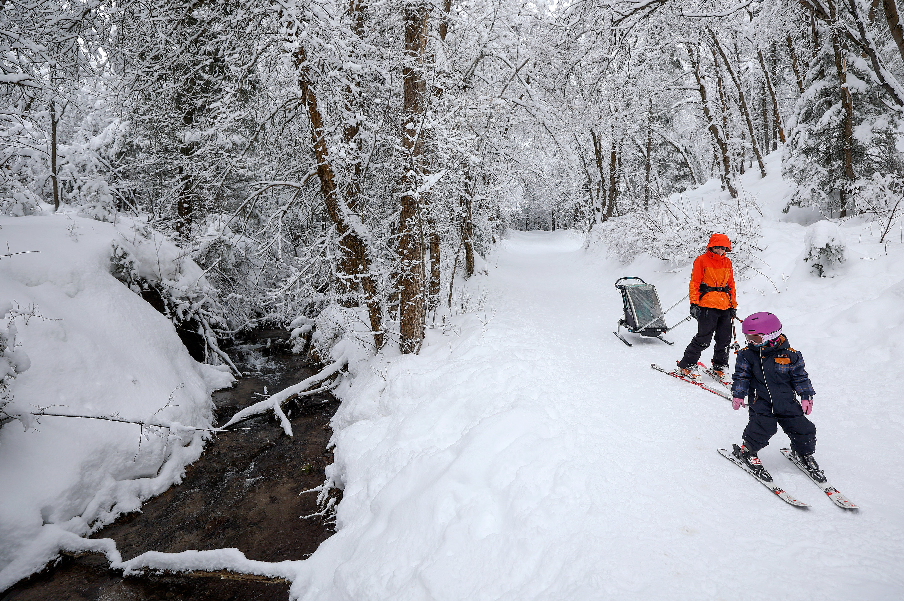 Johanna Youdin looks at Mill Creek as she and her mother Kaitlin Youdin ski in Millcreek Canyon on Jan. 3. Utah's statewide snowpack has already exceeded all of last year's total.