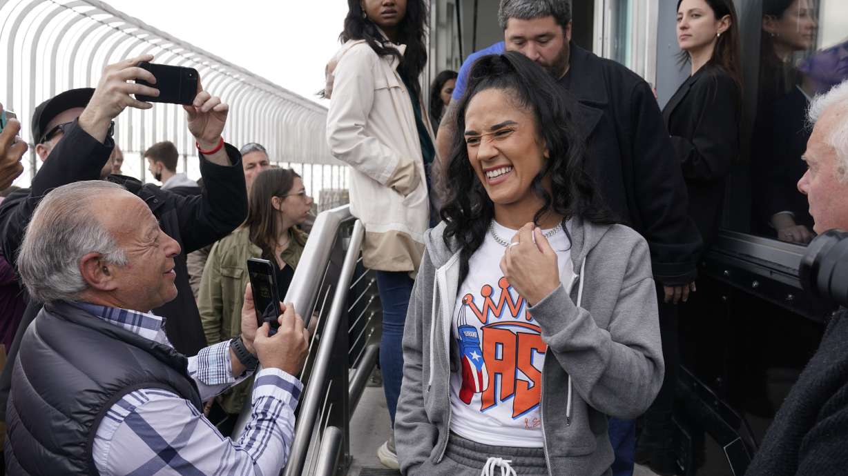 FILE - Boxer Amanda Serrano, center, arrives for a photo opportunity on the observation deck of the Empire State Building in New York on April 26, 2022. Serrano's next fight comes Saturday, Feb. 4, 2023, where she can become undisputed featherweight champion with a victory over Erika Cruz, the main event on a female-filled card at Madison Square Garden.