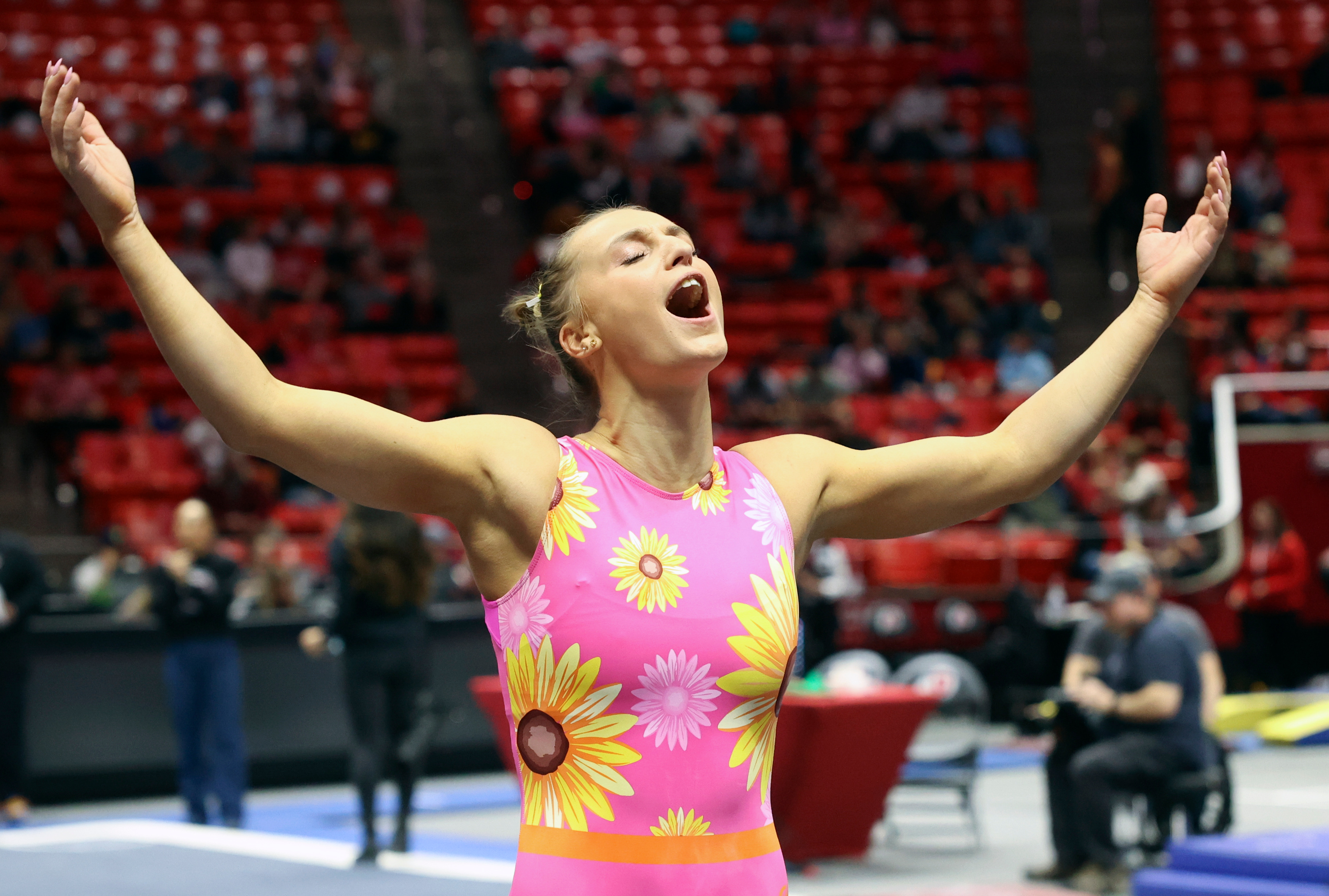 Abby Brenner motions for the crowd to cheer during the University of Utah Red Rocks gymnastics preview at the Huntsman Center Salt Lake City on Friday, Dec. 9, 2022.