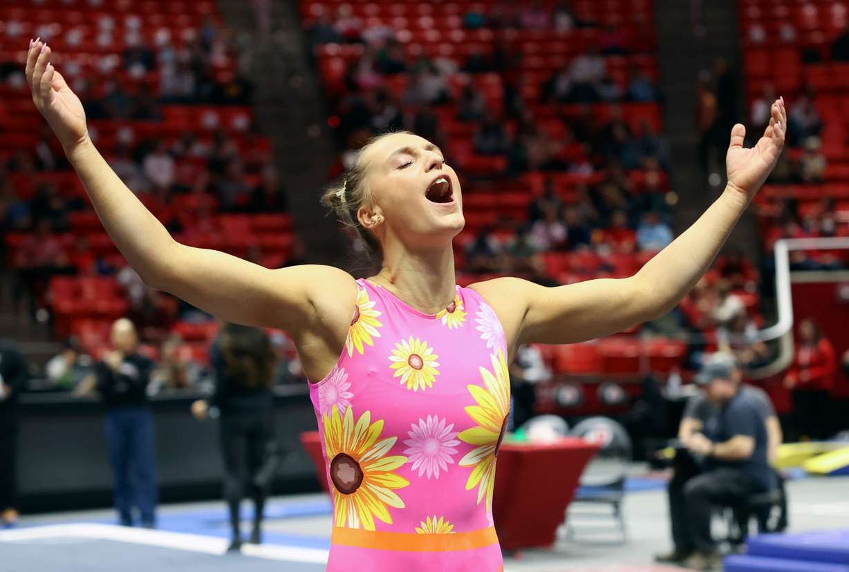 Abby Brenner motions for the crowd to cheer during the University of Utah Red Rocks gymnastics preview at the Huntsman Center Salt Lake City on Friday, Dec. 9, 2022.