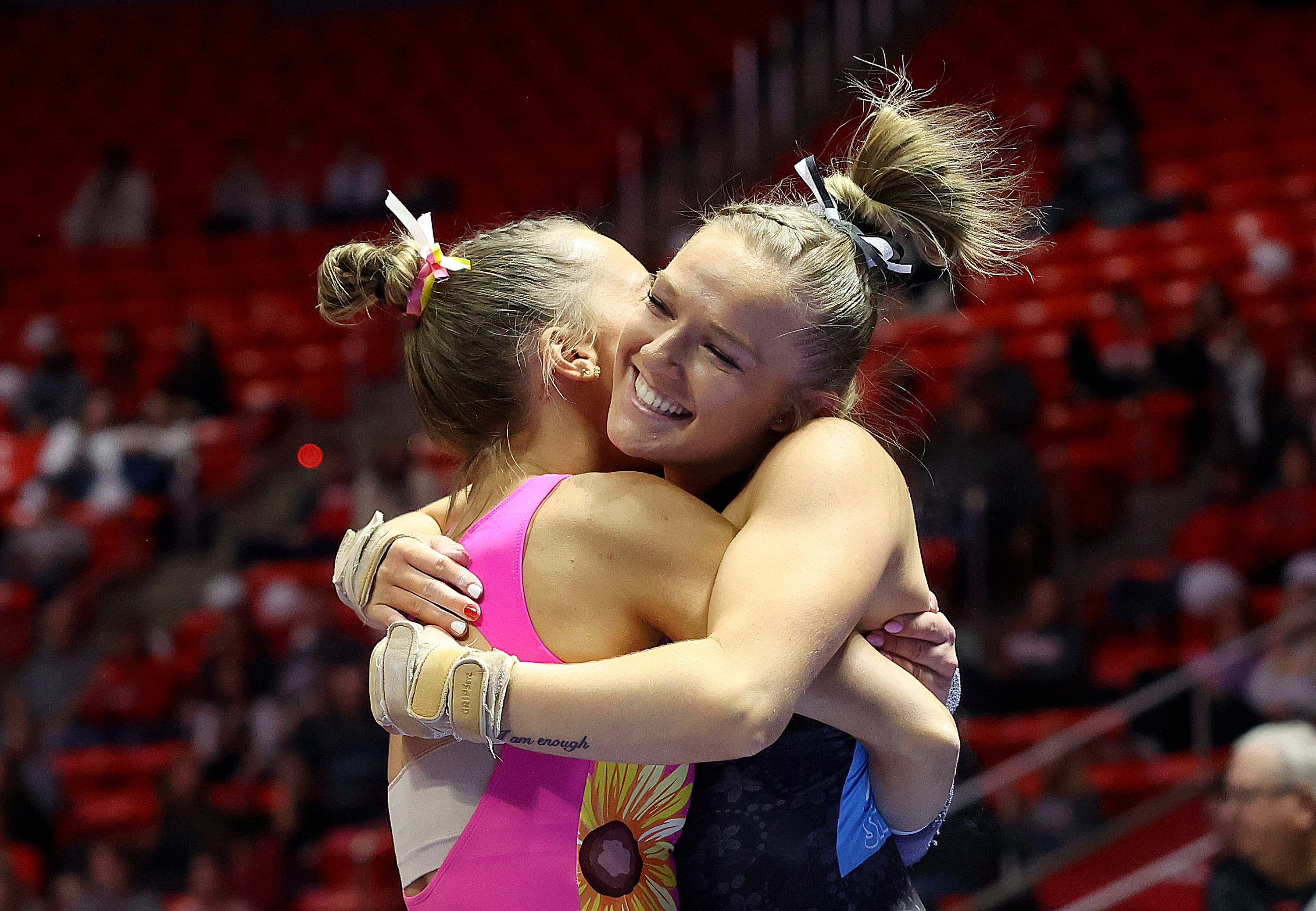 Abby Brenner, left, hugs Jillian Hoffman after Hoffman’s vault during the University of Utah Red Rocks gymnastics preview at the Huntsman Center Salt Lake City on Friday, Dec. 9, 2022.