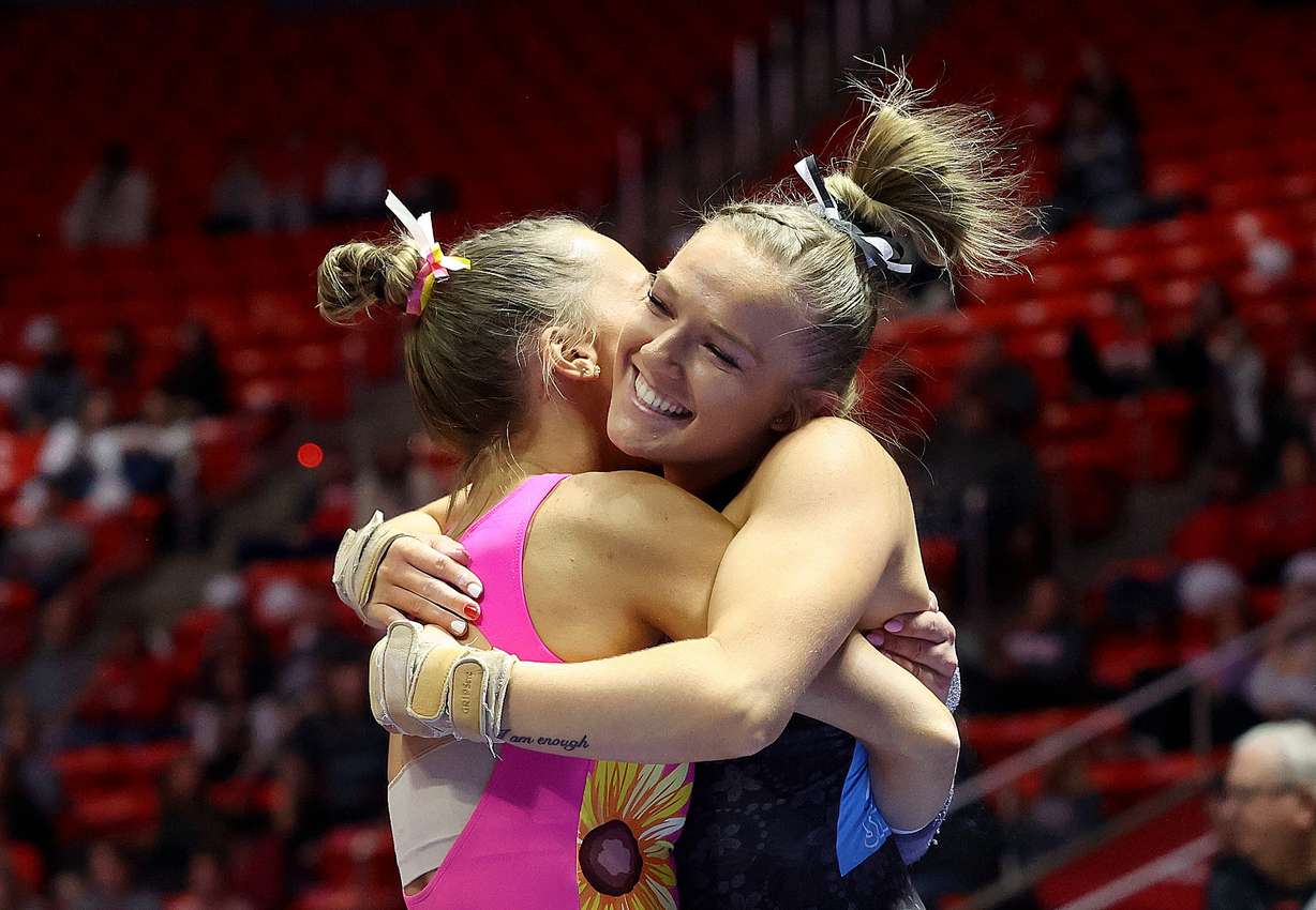 Abby Brenner, left, hugs Jillian Hoffman after Hoffman’s vault during the University of Utah Red Rocks gymnastics preview at the Huntsman Center Salt Lake City on Friday, Dec. 9, 2022.