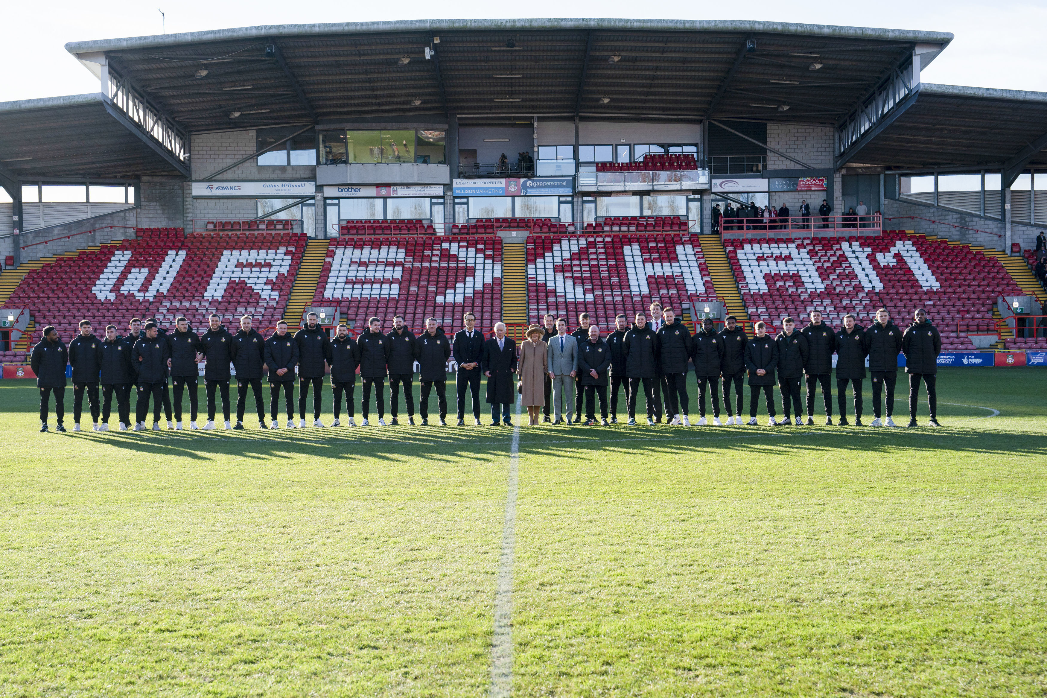 FILE - Britain's King Charles III and Camilla, the Queen Consort meet Wrexham Soccer team co owners, US actors Ryan Reynolds and Rob McElhenney and players during their visit to Wrexham Association Football Club's Racecourse Ground, in Wrexham, England, Friday, Dec. 9, 2022. The Hollywood owners of Wrexham are still learning the vernacular of British soccer. They don’t need any advice, though, in setting the scene for this weekend’s FA Cup match against second-division Sheffield United. 