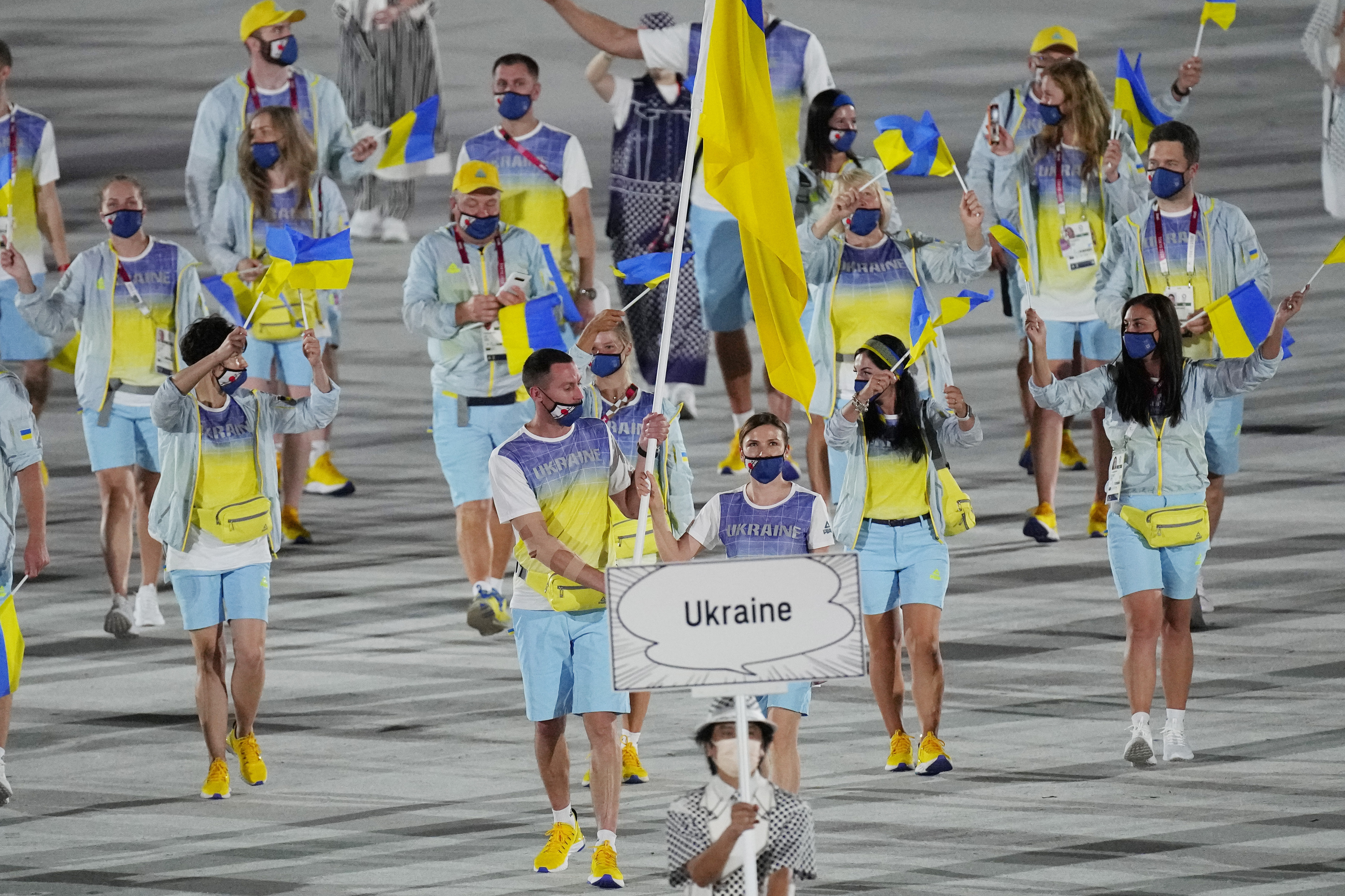 FILE - Olena Kostevych and Bogdan Nikishin, of Ukraine, carry their country's flag during the opening ceremony in the Olympic Stadium at the 2020 Summer Olympics, on July 23, 2021, in Tokyo, Japan. Ukraine has stepped up efforts to lobby international sports leaders against Russian participation in next year’s Paris Olympics as indications mount that the games could see the biggest boycott since the Cold War.