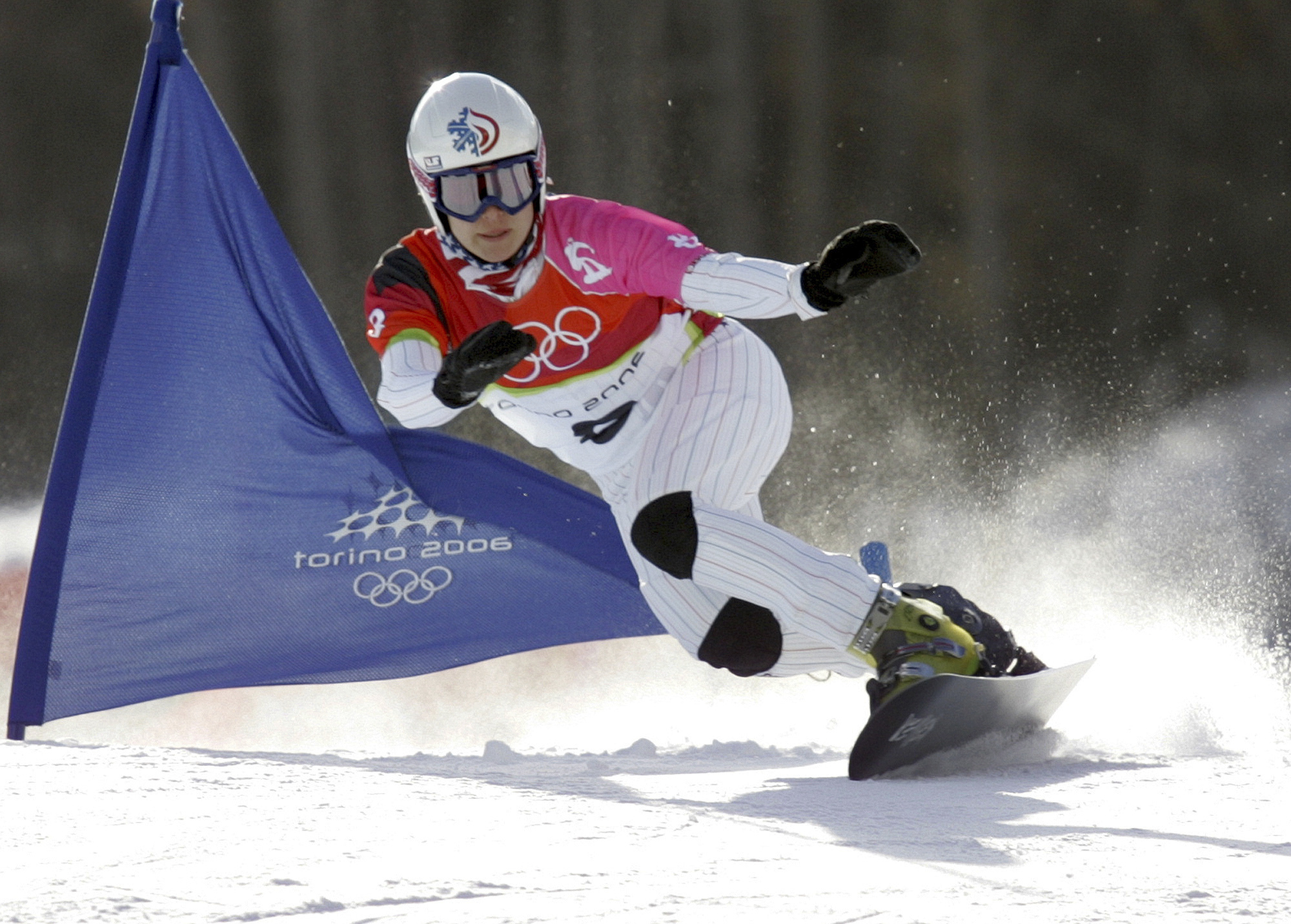 FILE - United States Rosey Fletcher clears a gate during the women's snowboard parallel giant slalom race at the Turin 2006 Winter Olympic Games in Bardonecchia, Italy, on Feb. 23, 2006. Olympic bronze medalist Rosey Fletcher filed a lawsuit accusing former snowboard coach Peter Foley of sexually assaulting, harassing and intimidating members of his team for years, while the organizations overseeing the team did nothing to stop it. Fletcher is a plaintiff in one of two lawsuits filed in U.S. District Court in Los Angeles on Thursday, Feb. 2, 2023. 
