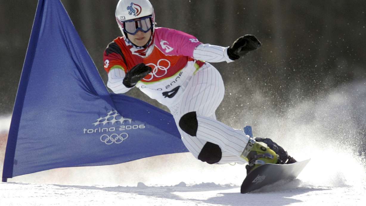 FILE - United States Rosey Fletcher clears a gate during the women's snowboard parallel giant slalom race at the Turin 2006 Winter Olympic Games in Bardonecchia, Italy, on Feb. 23, 2006. Olympic bronze medalist Rosey Fletcher filed a lawsuit accusing former snowboard coach Peter Foley of sexually assaulting, harassing and intimidating members of his team for years, while the organizations overseeing the team did nothing to stop it. Fletcher is a plaintiff in one of two lawsuits filed in U.S. District Court in Los Angeles on Thursday, Feb. 2, 2023.