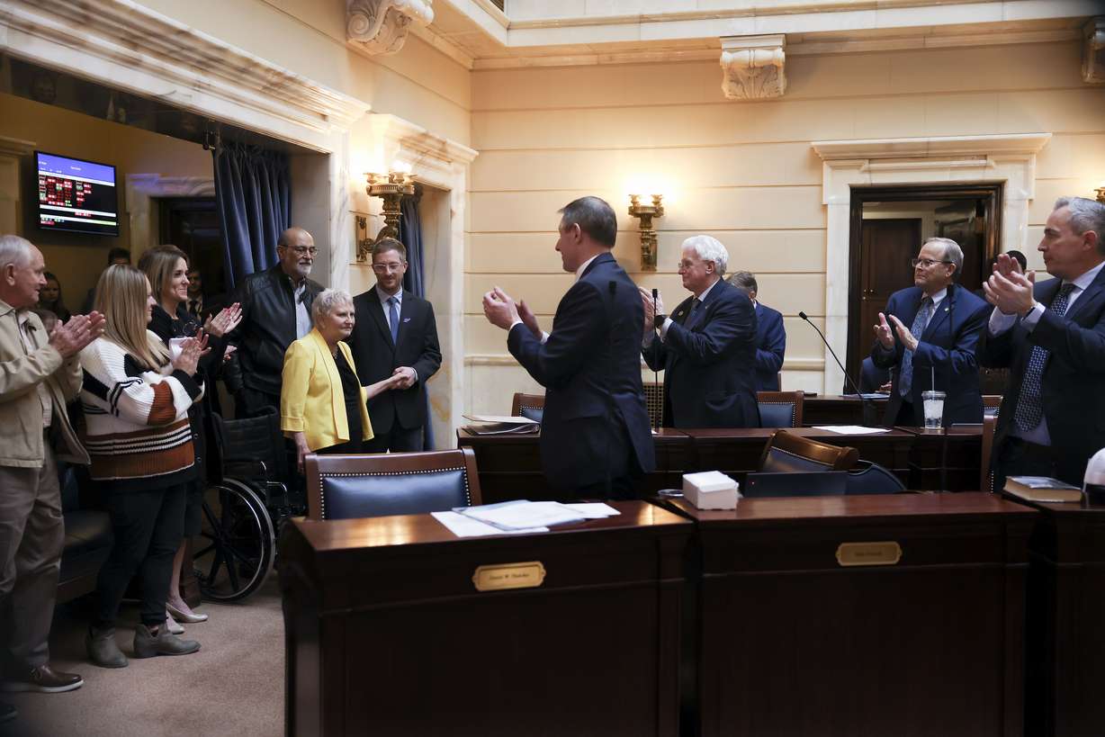 Former Sen. Karen Mayne receives a standing ovation in the Senate after a bill that creates a scholarship for law enforcement officers passed at the Capitol in Salt Lake City on Friday. The scholarship is named after Mayne, who retired earlier this year.