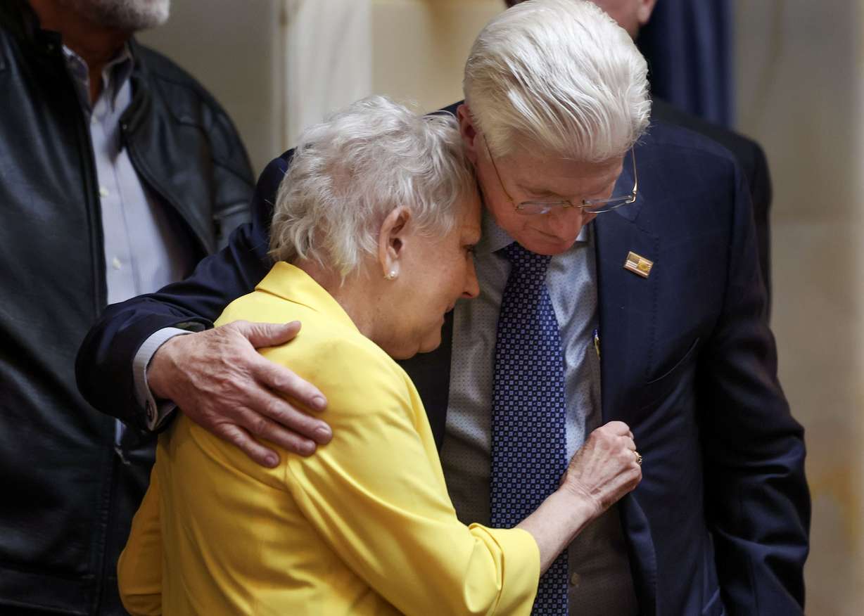 Former Sen. Karen Mayne embraces Sen. Don Ipson, R-St. George, in the Senate after a bill that creates a scholarship for law enforcement officers passed at the Capitol in Salt Lake City on Friday. The scholarship is named after Mayne, who retired earlier this year.