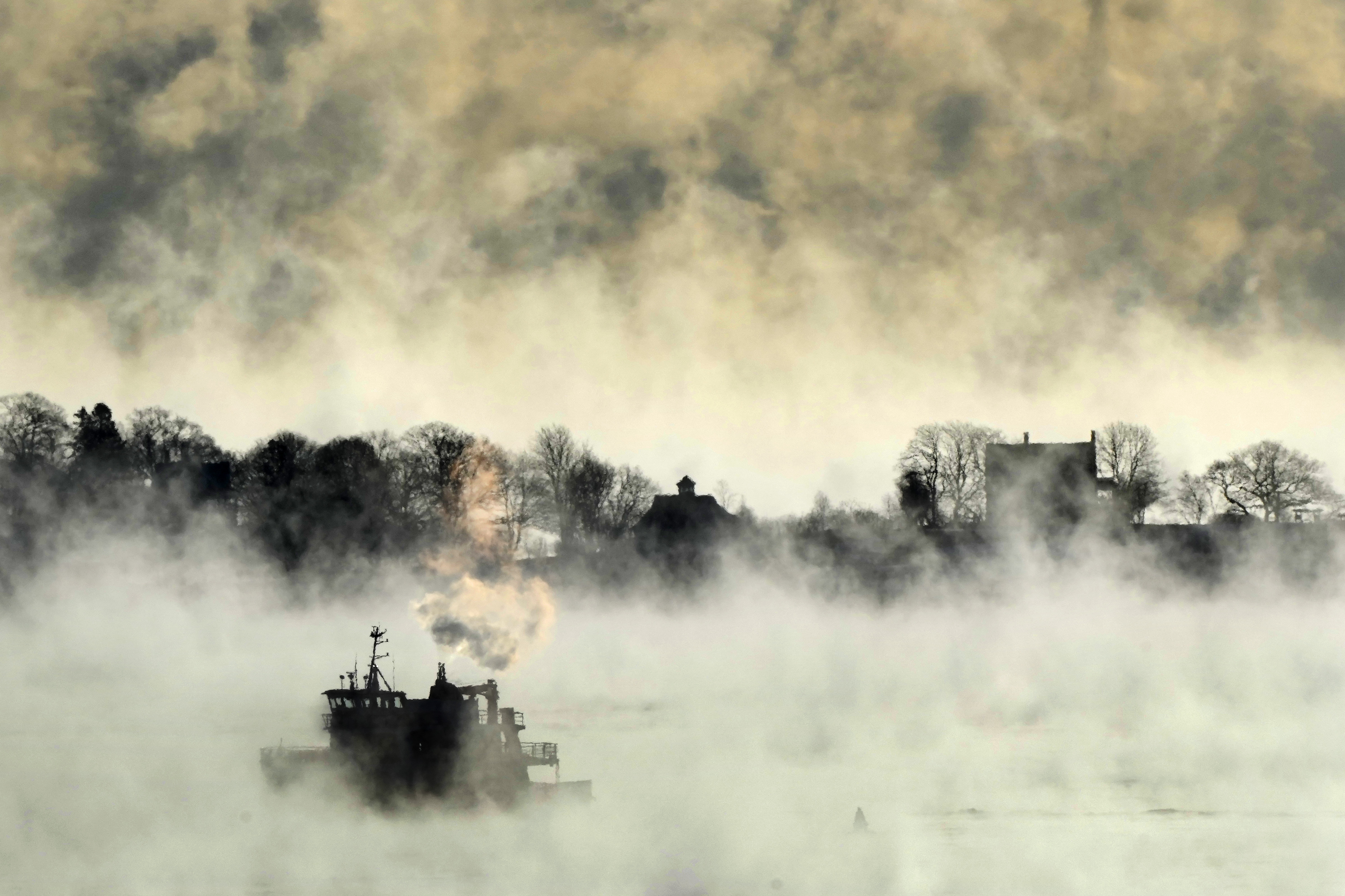 Arctic sea smoke rises from the the Atlantic Ocean as a passenger ferry passes House Island Saturday, off the coast of Portland, Maine. The morning temperature was about -10 degrees Fahrenheit.
