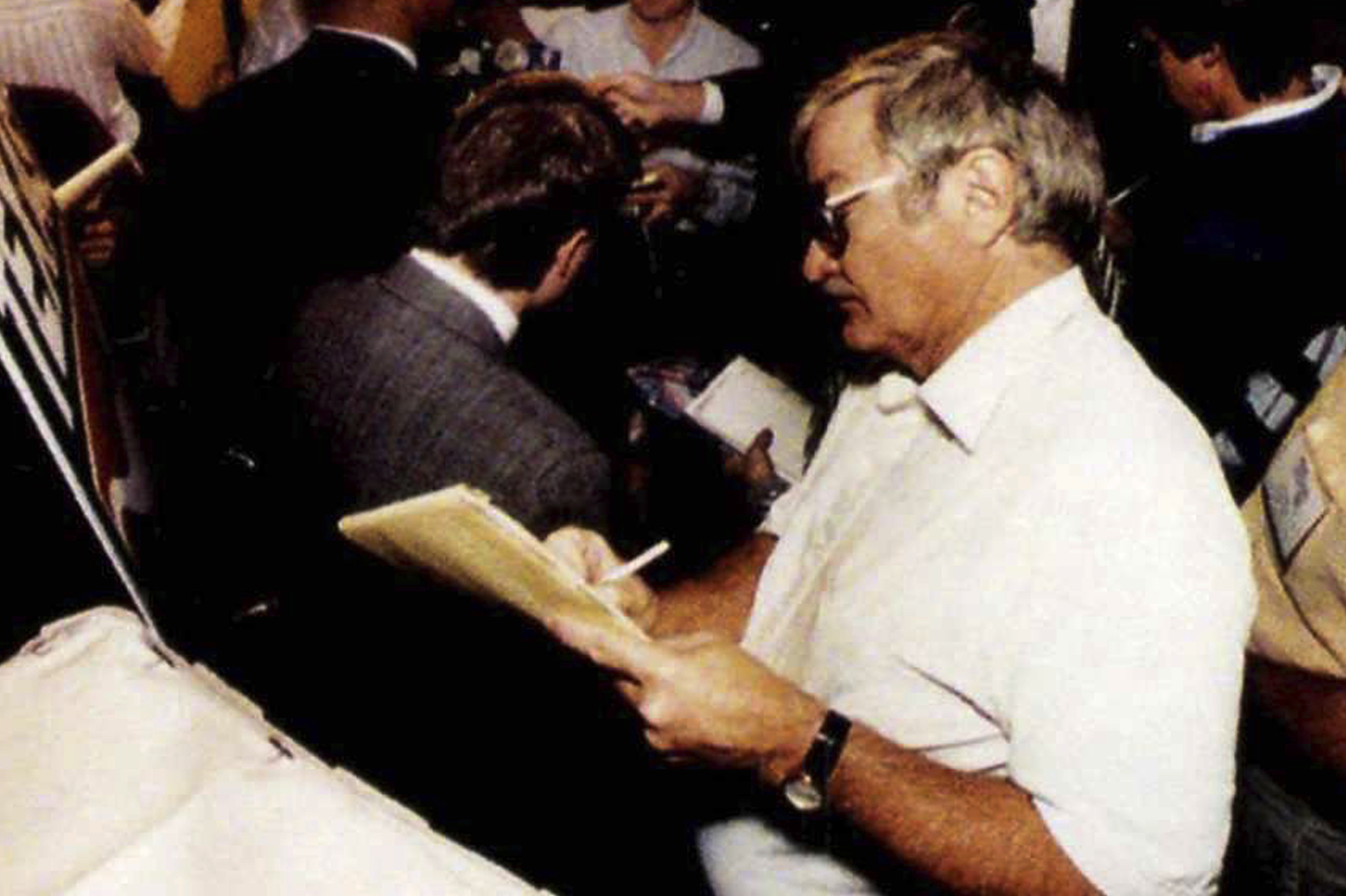 FILE - Texas sports editor, Denne Freeman listens to University of Texas Safety Stanley Richard during a news conference in Irving, Texas, just before the Cotton Bowl in 1991. Freeman, whose 32 years with the AP included covering all five Super Bowl championships won by the Dallas Cowboys and many golf majors, has died, Friday, Feb. 3, 2023 after a series of health issues. He was 86. 